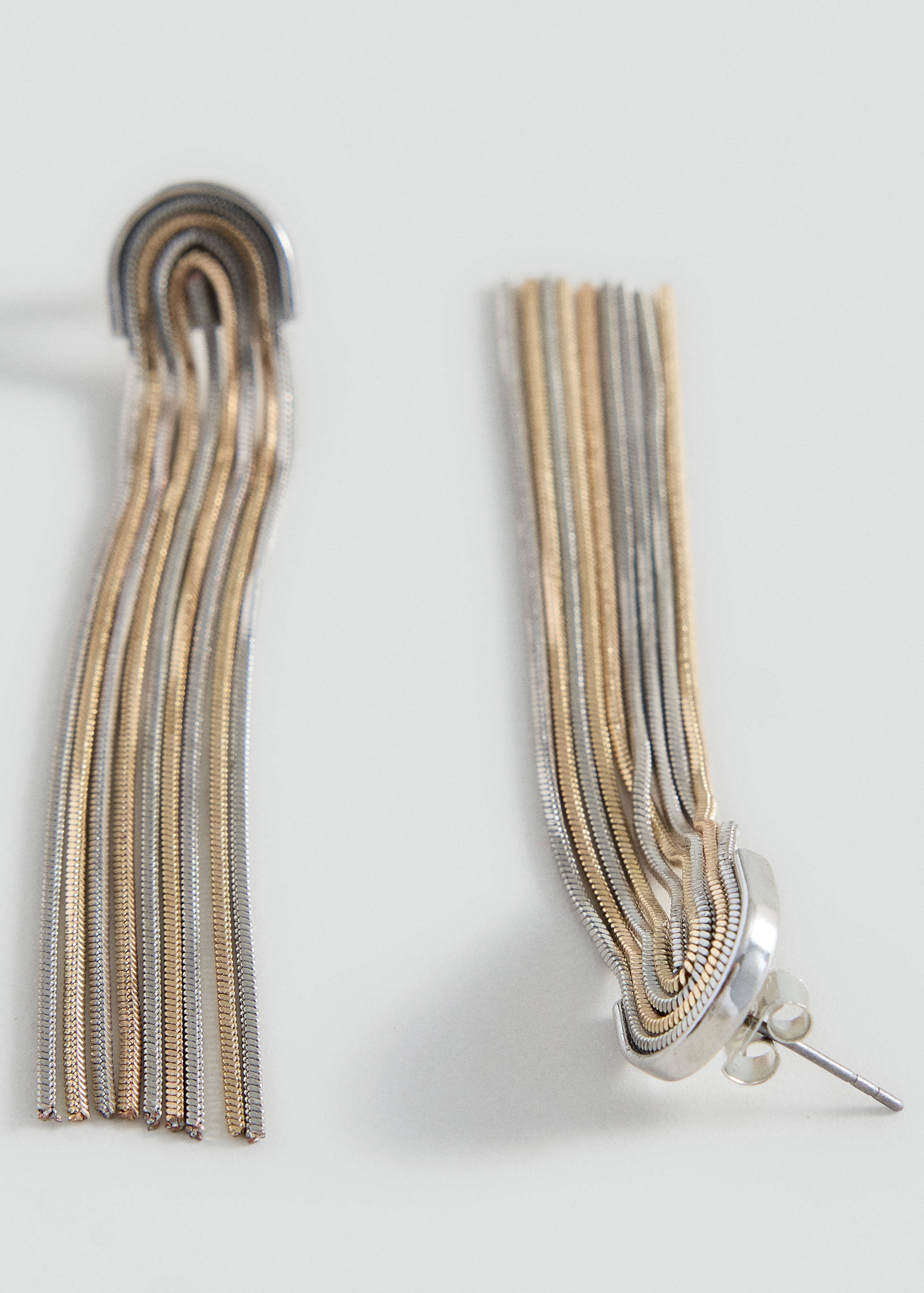 Long multi-strand fringe earrings in alternating silver and gold tones.