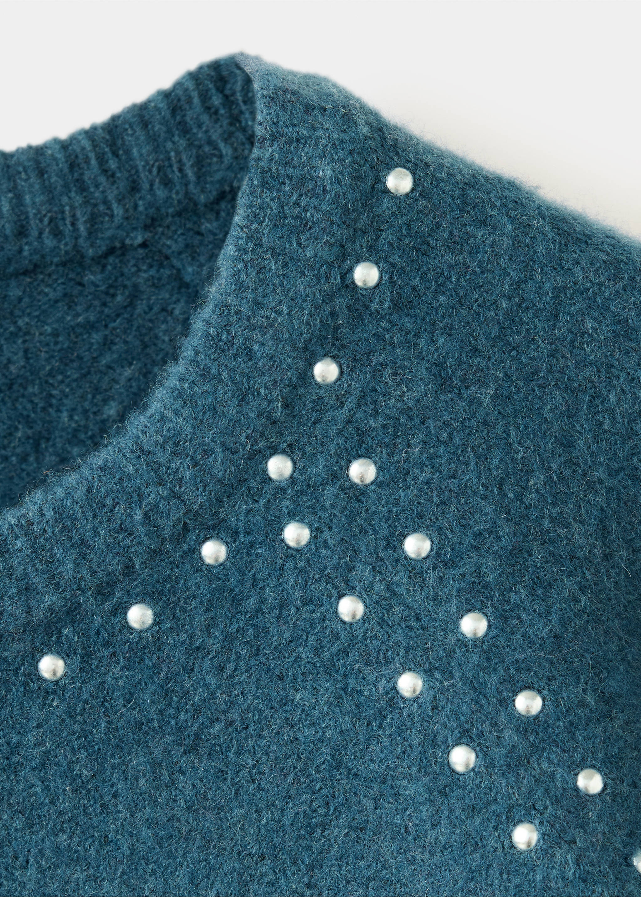 Close-up of a dark teal knitted jersey with silver stud details., Petrol Blue. Ref: 37016357-00.