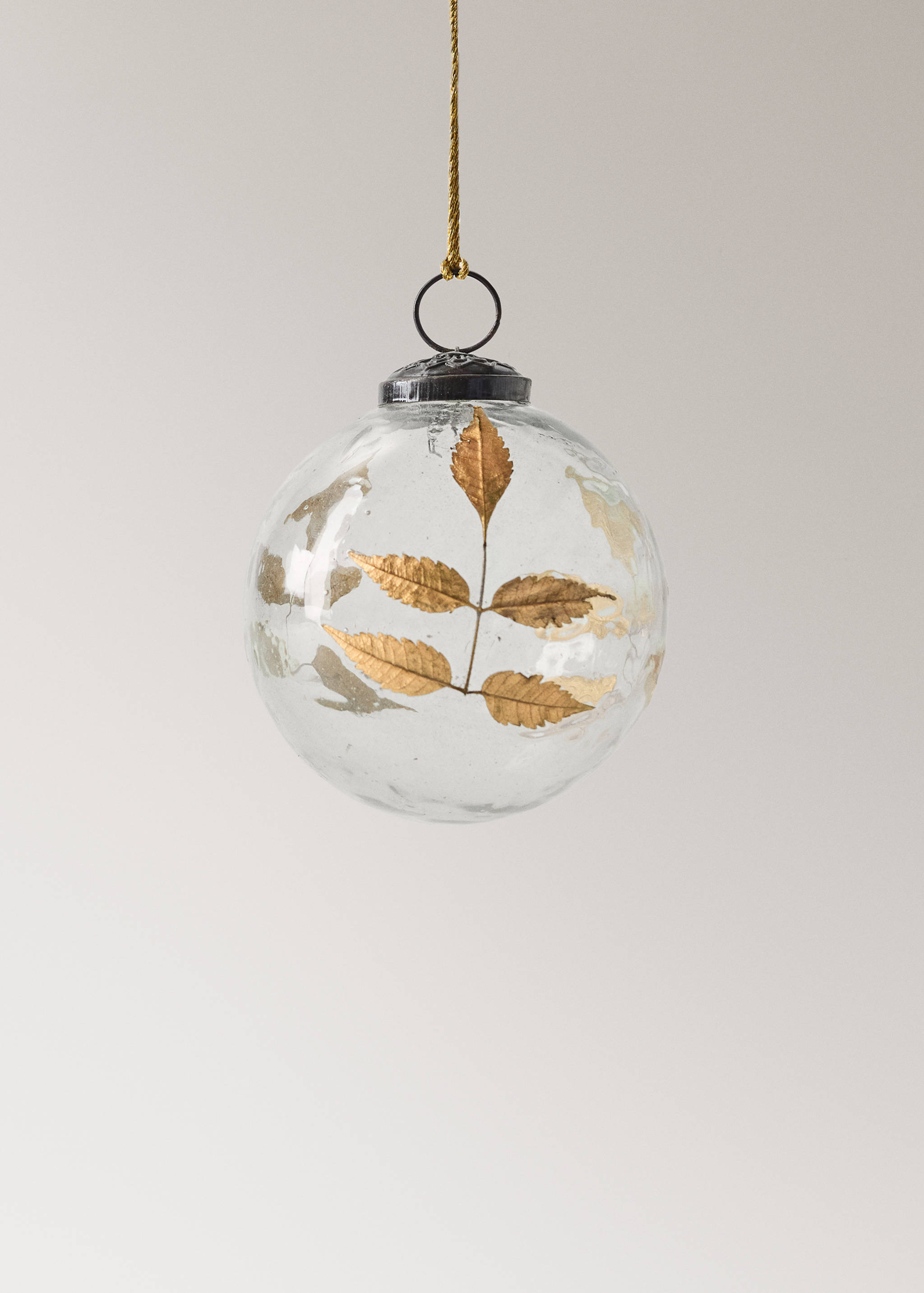 Clear glass Christmas bauble with gold leaf details and a metallic cap.