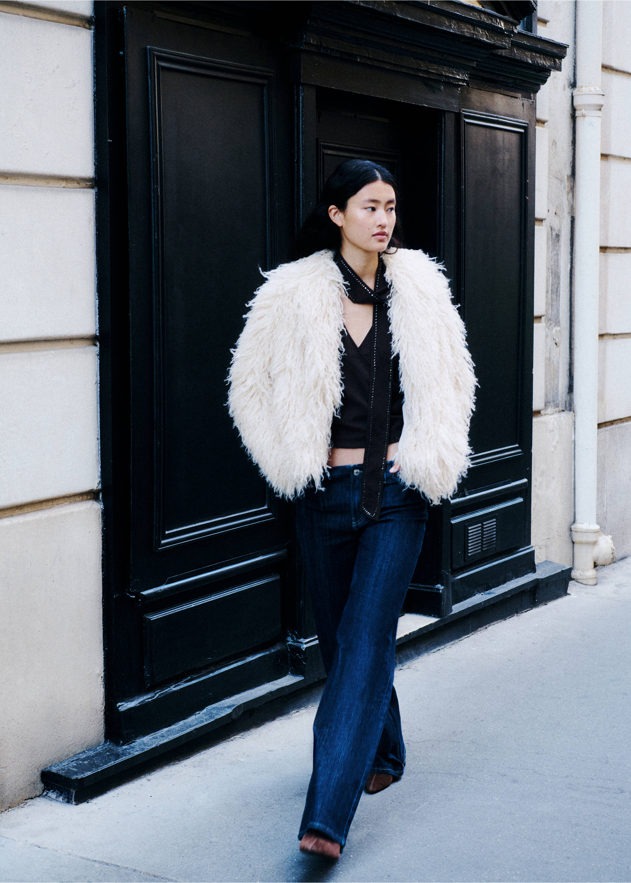 Off-white textured fringe coat worn with a dark V-neck top and blue denim trousers., Ivory White. Ref: 37016742-01.