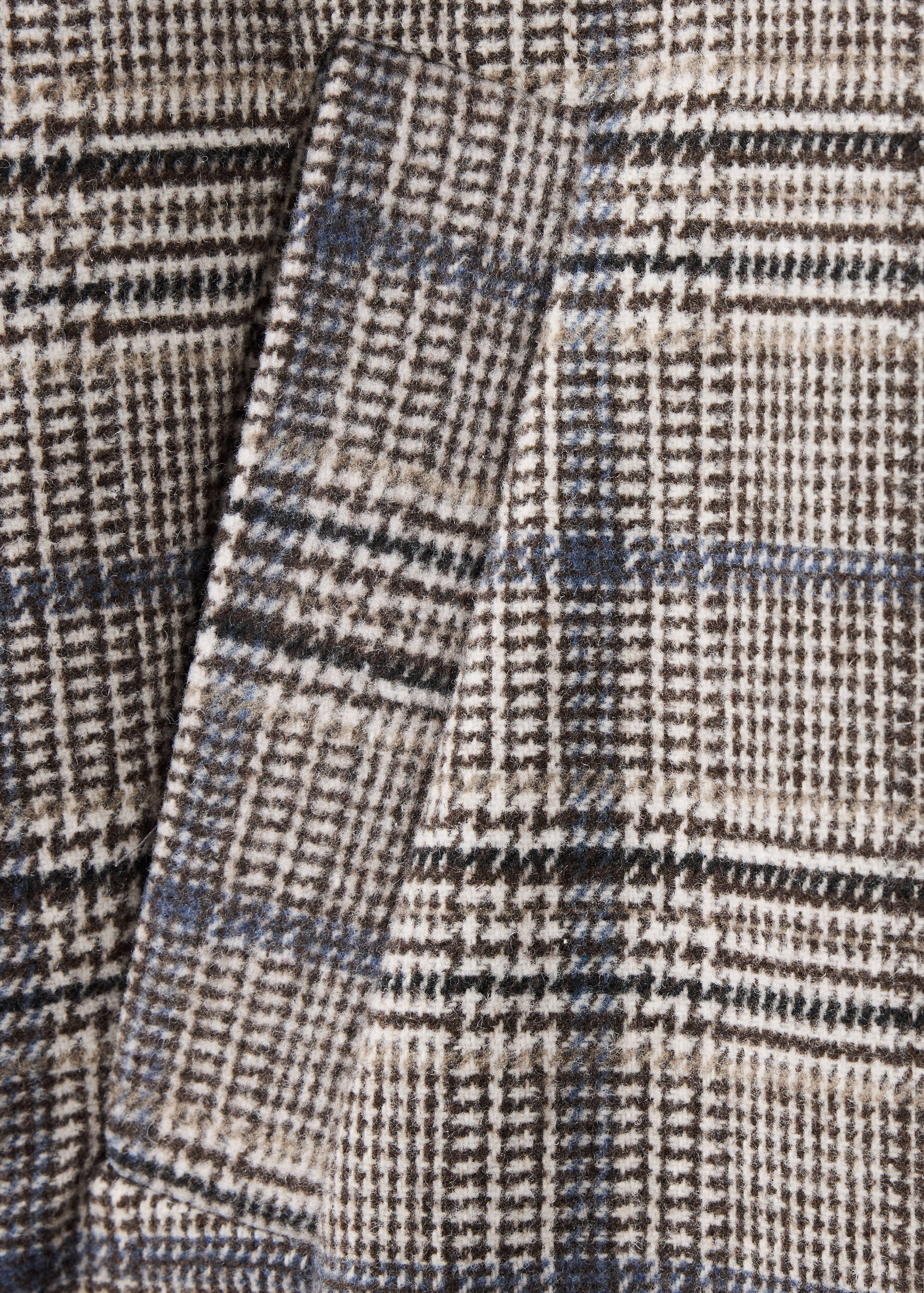 Close-up of the brown and blue plaid coat fabric texture.