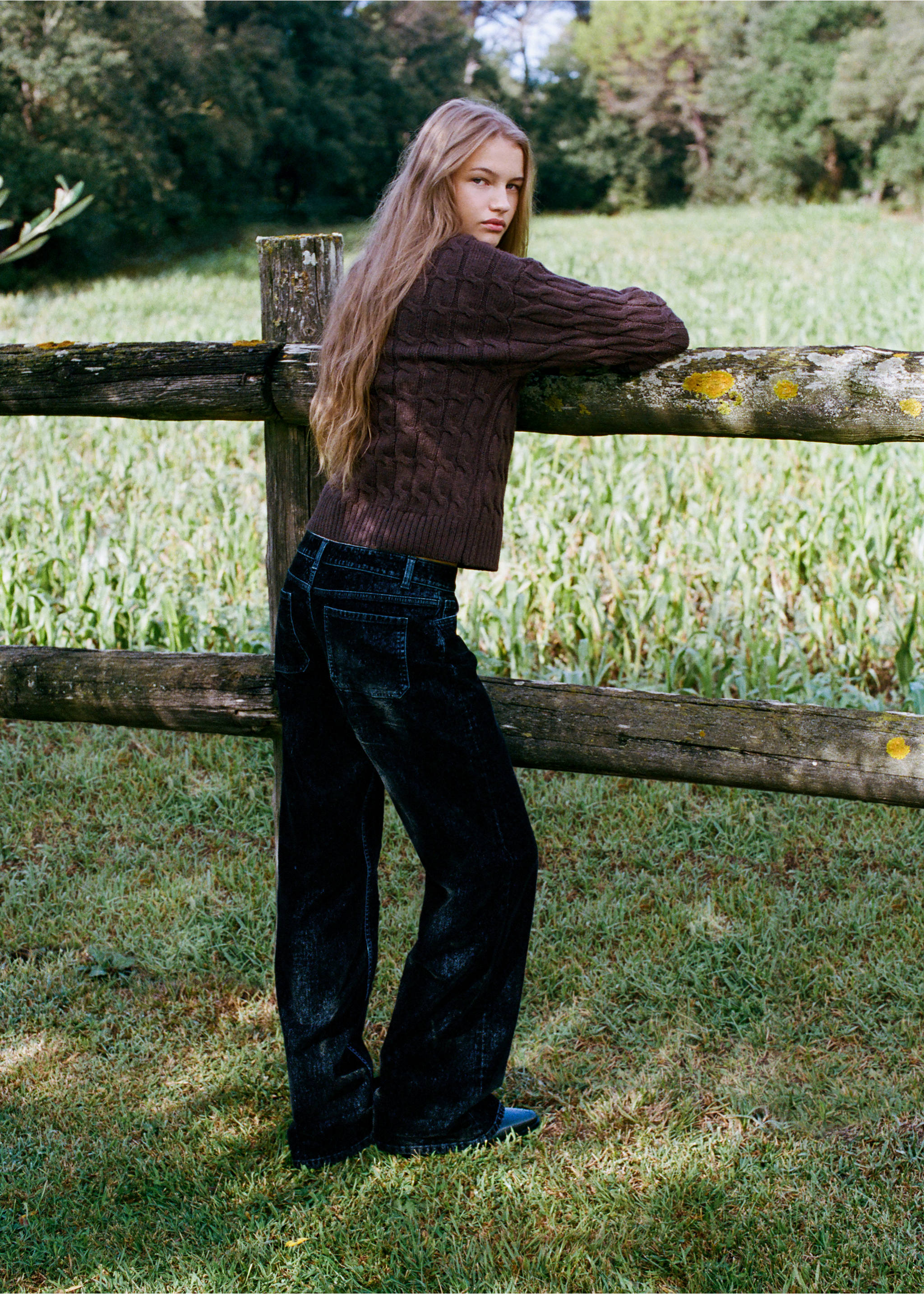 Dark blue denim trousers worn with a brown cable-knit sweater, shown from the back in an outdoor setting., Navy. Ref: 37017135-00.