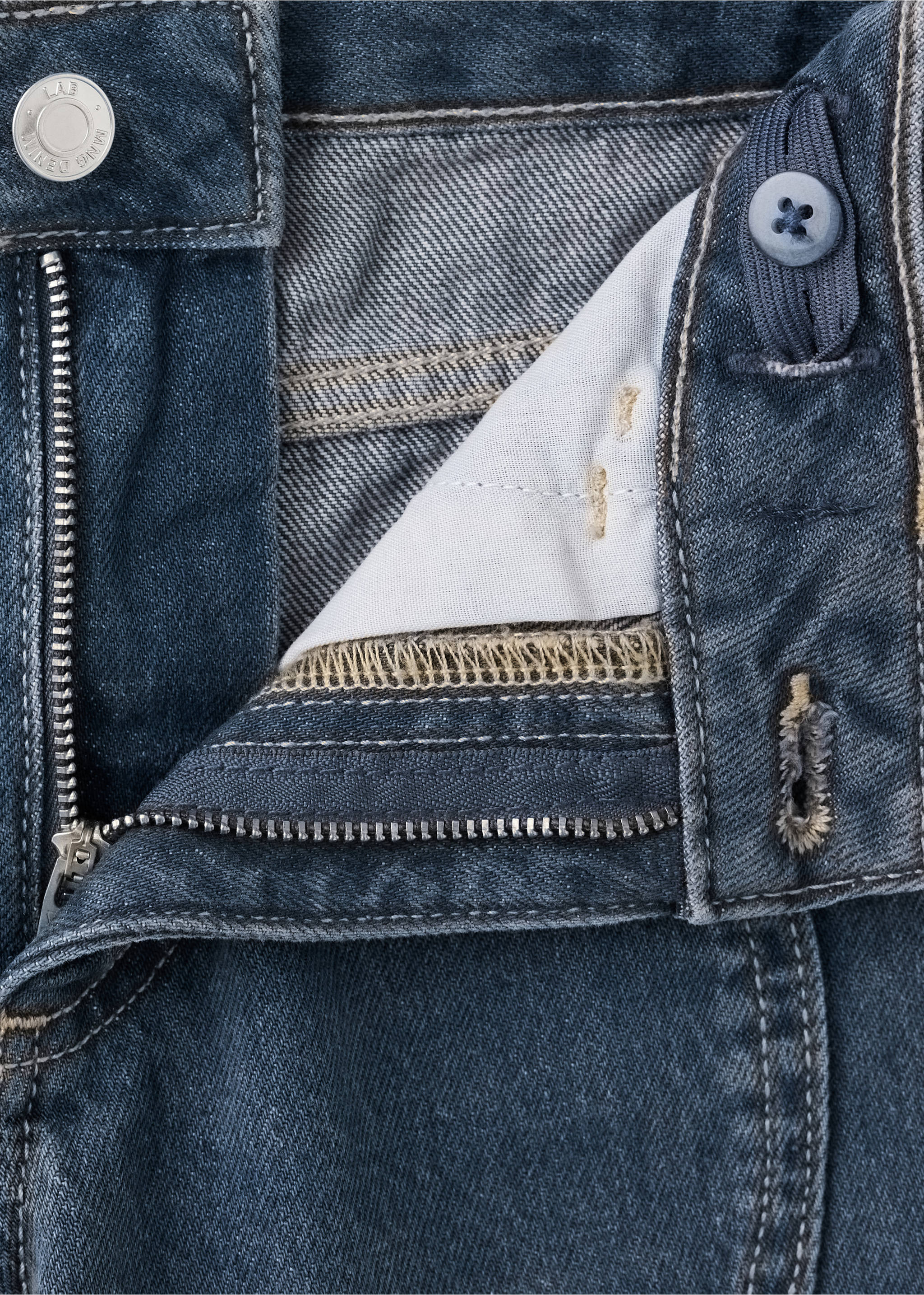 Close-up of blue denim trousers with zip fly and button detail., Medium Vintage Blue. Ref: 37017140-00.
