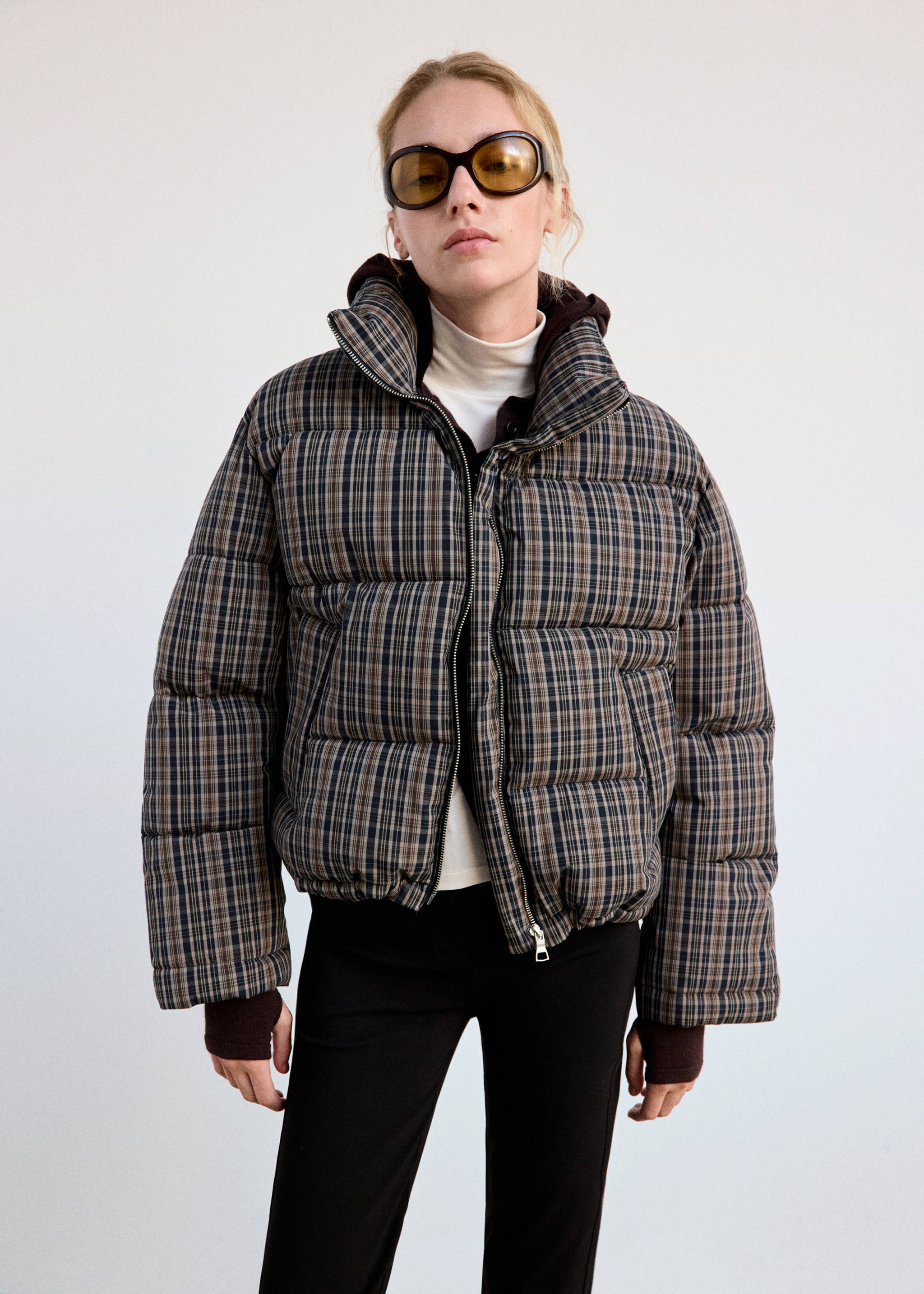 Brown checked quilted anorak with high funnel neck and zip front.