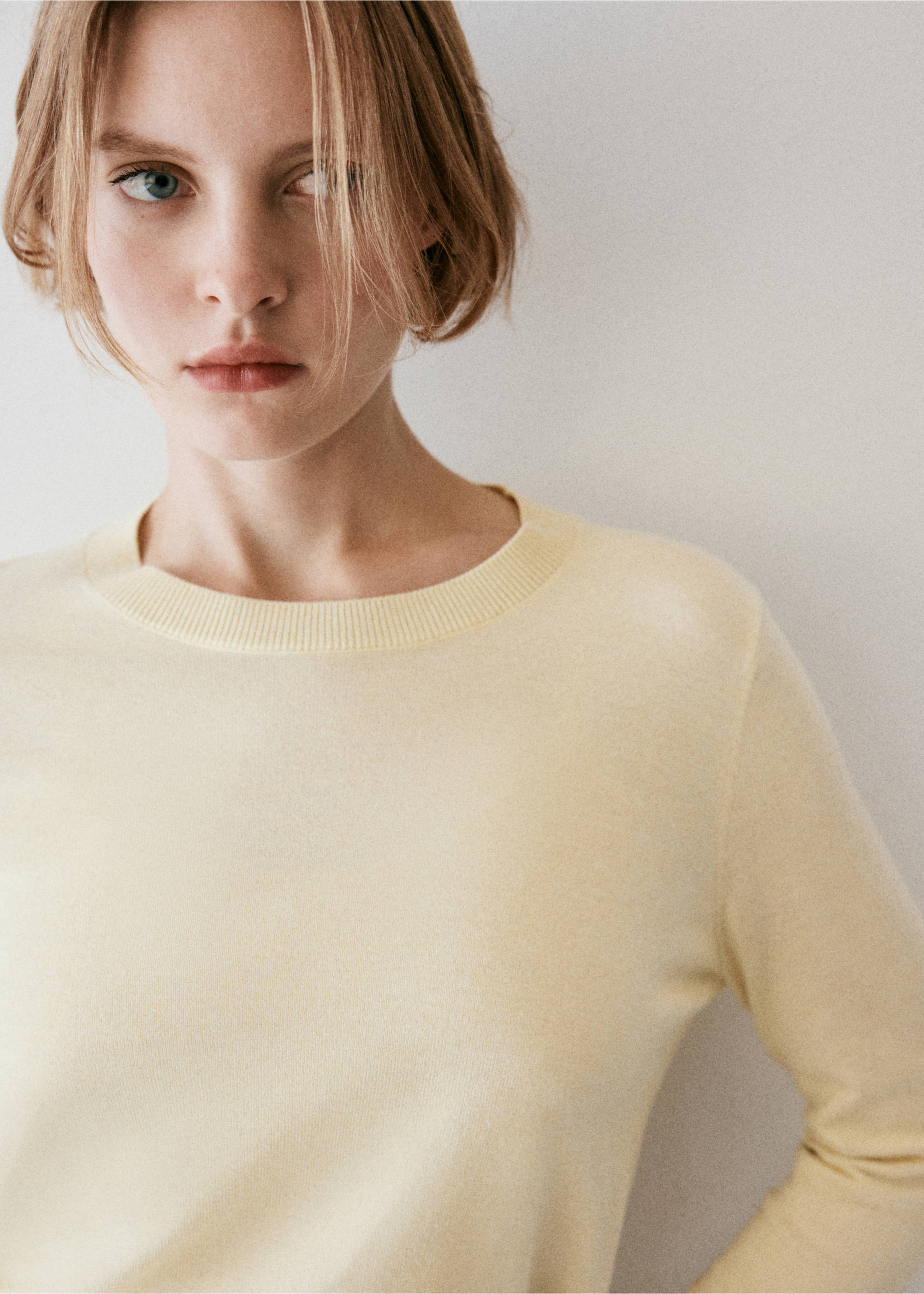Close-up of a pastel yellow jersey sweater with a round ribbed neckline., Pastel Yellow. Ref: 37017777-00.