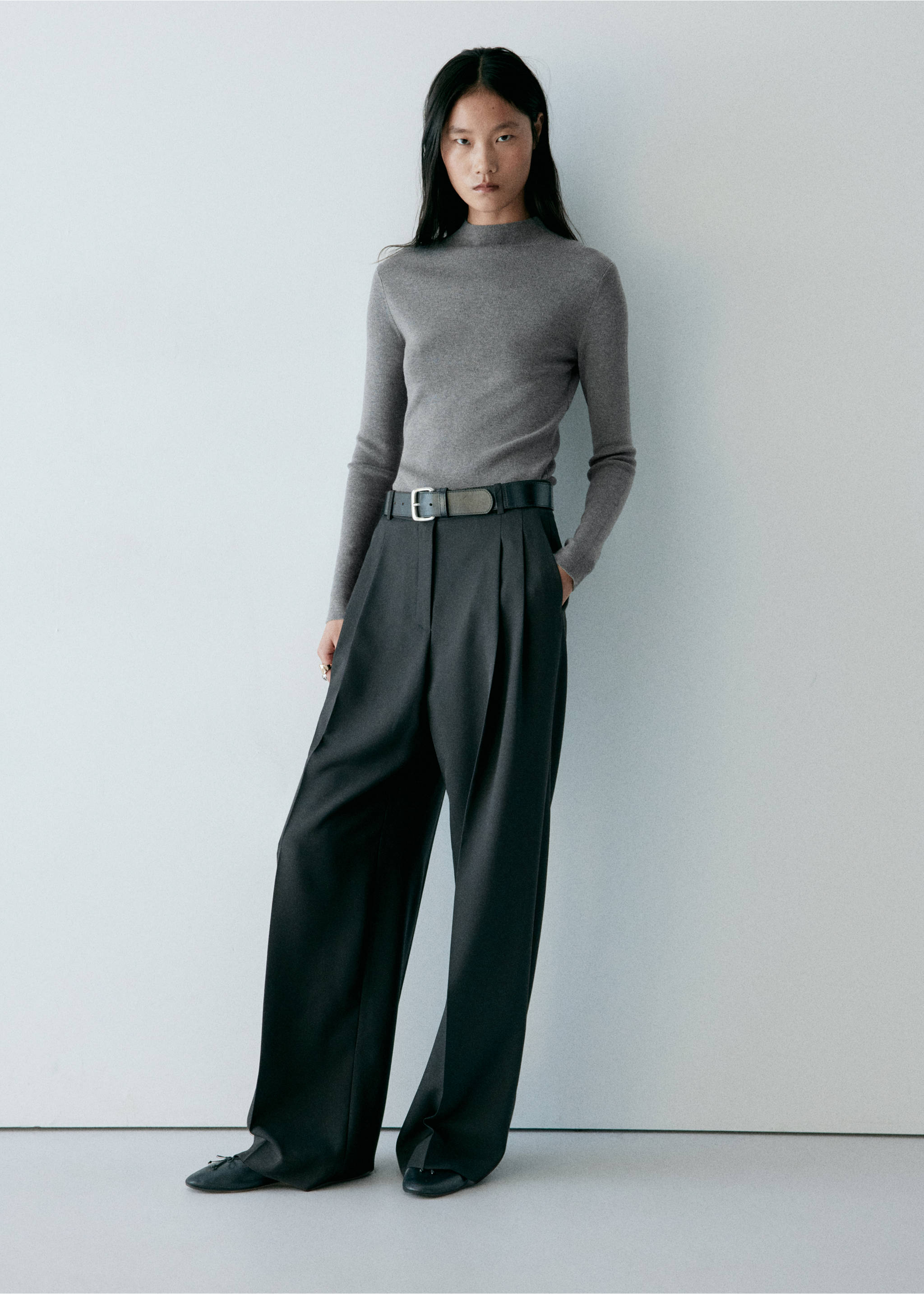 Grey fine-knit high-neck jersey worn with dark wide-leg trousers., Medium Heather Grey. Ref: 37017778-00.
