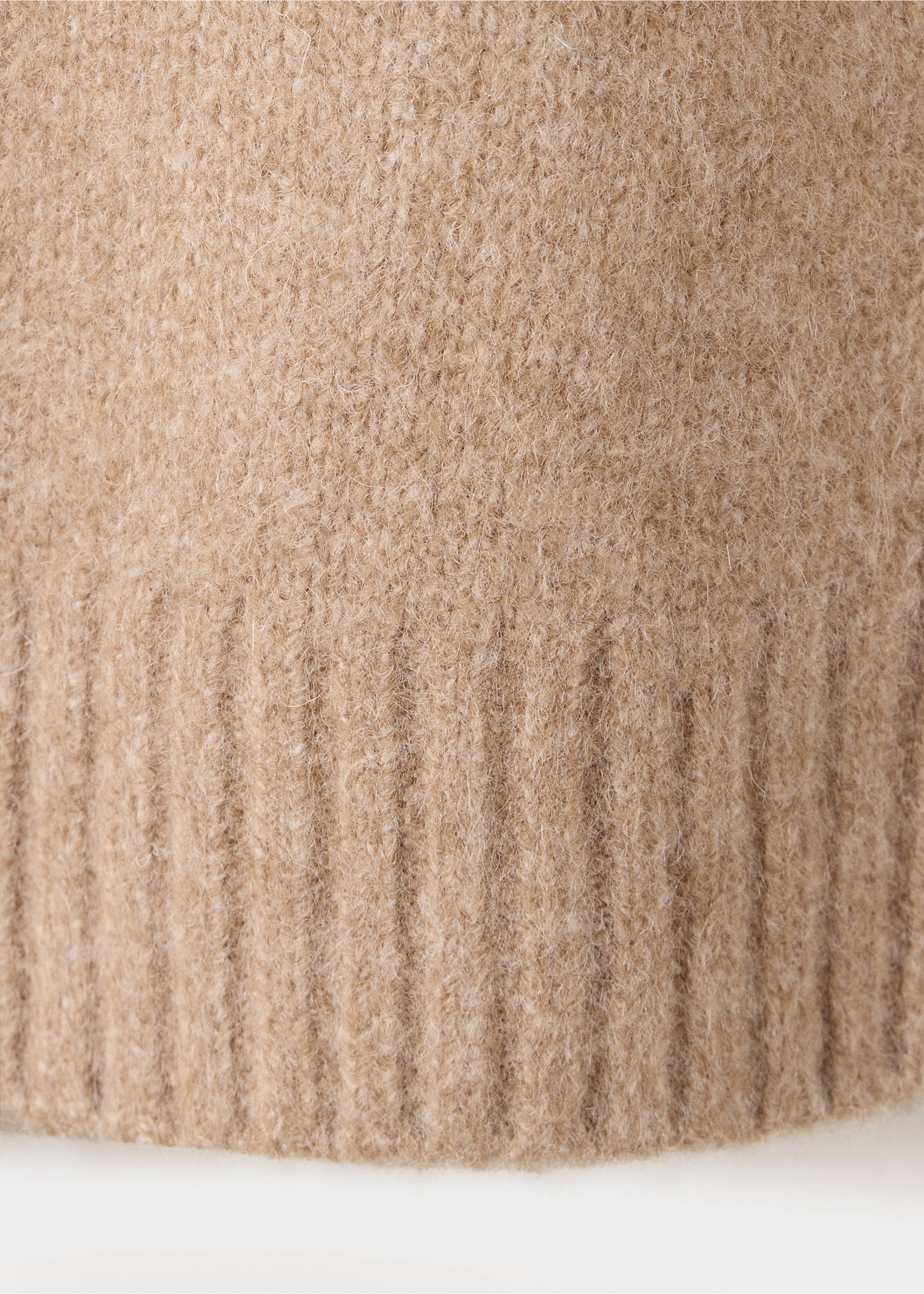 Close-up of a beige jersey sweater showing the soft, fuzzy texture and wide ribbed hem., Medium Brown. Ref: 37017781-00.