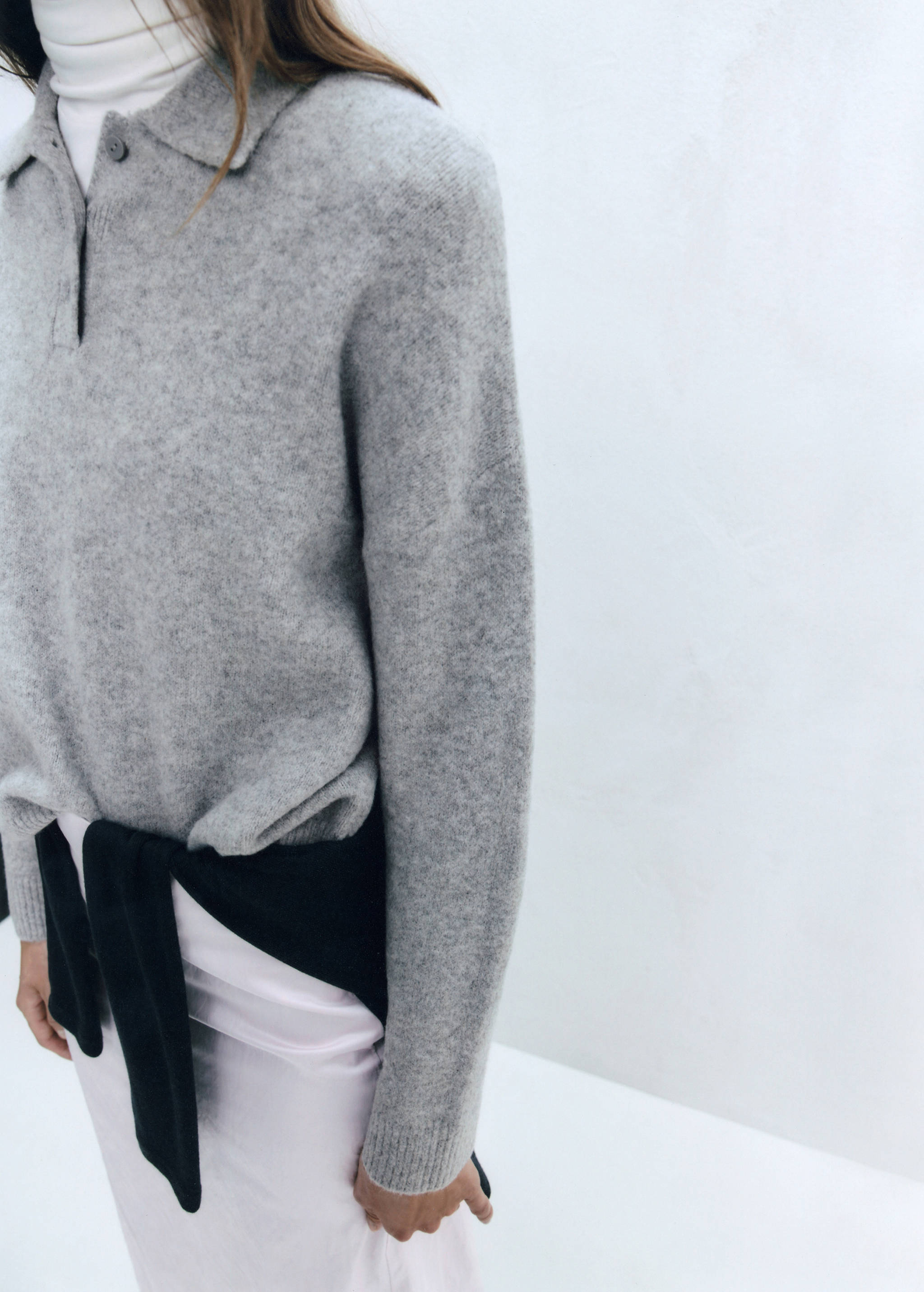 Grey melange knit polo sweater with a collar.