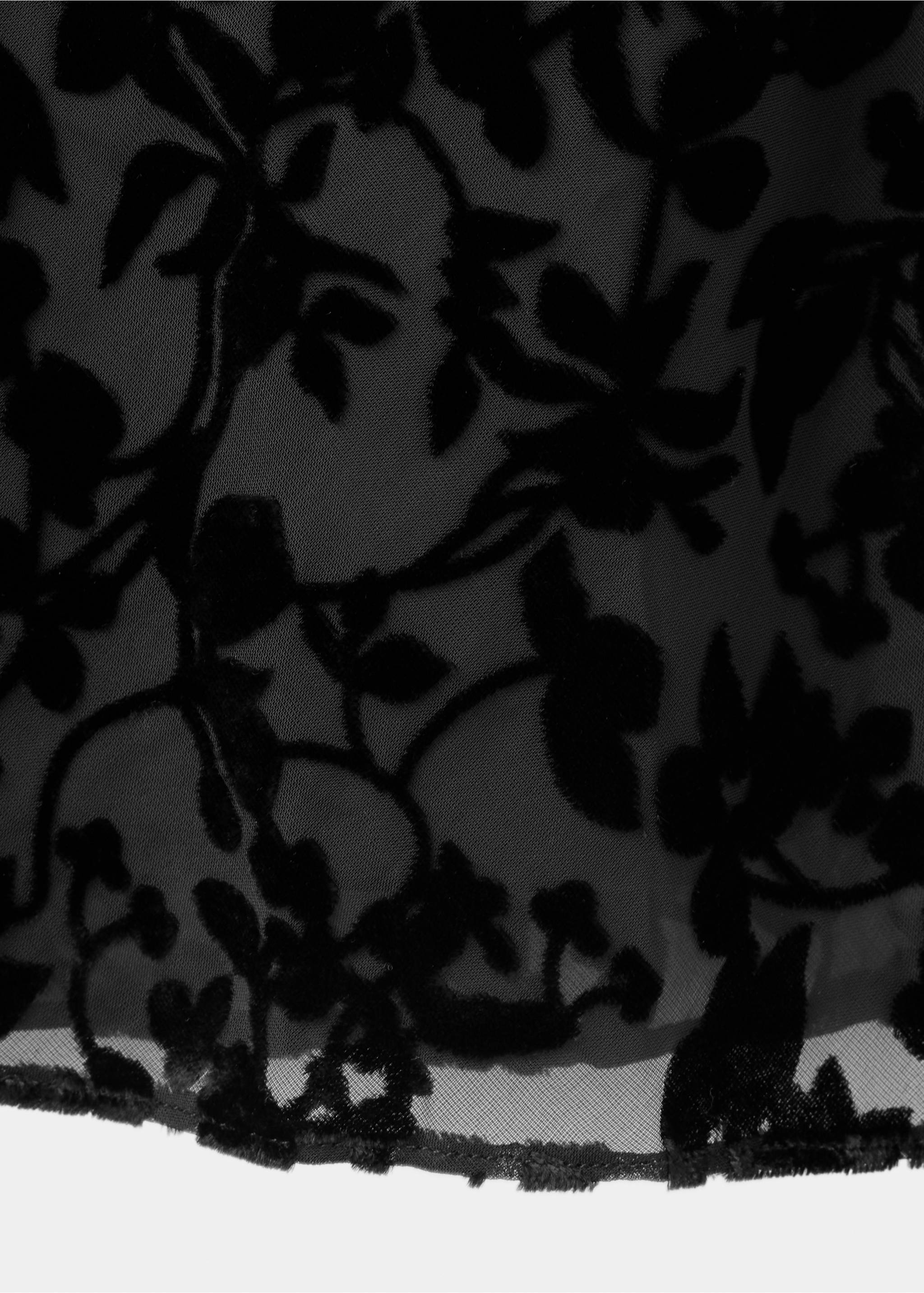 Close-up of black dress fabric with a sheer base and opaque floral pattern., Black. Ref: 37017786-00.