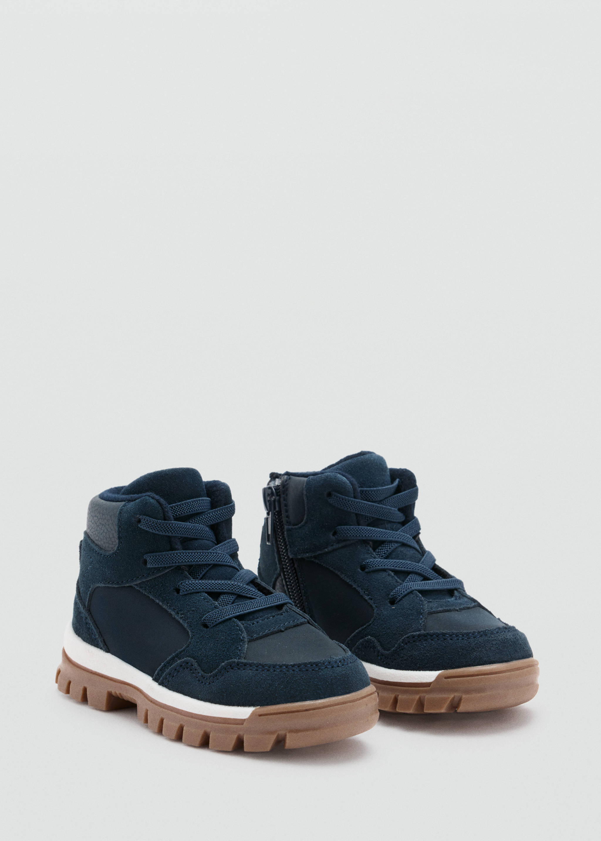 Navy blue children's high-top boots with side zips and lugged soles.