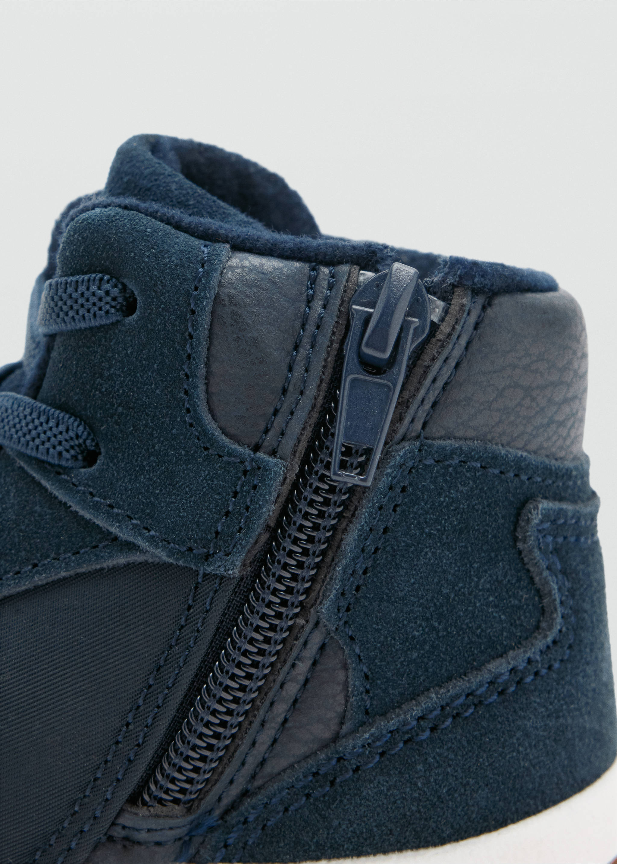 Close-up of navy blue boot showing side zip and textured panels., Navy. Ref: 37017788-00.