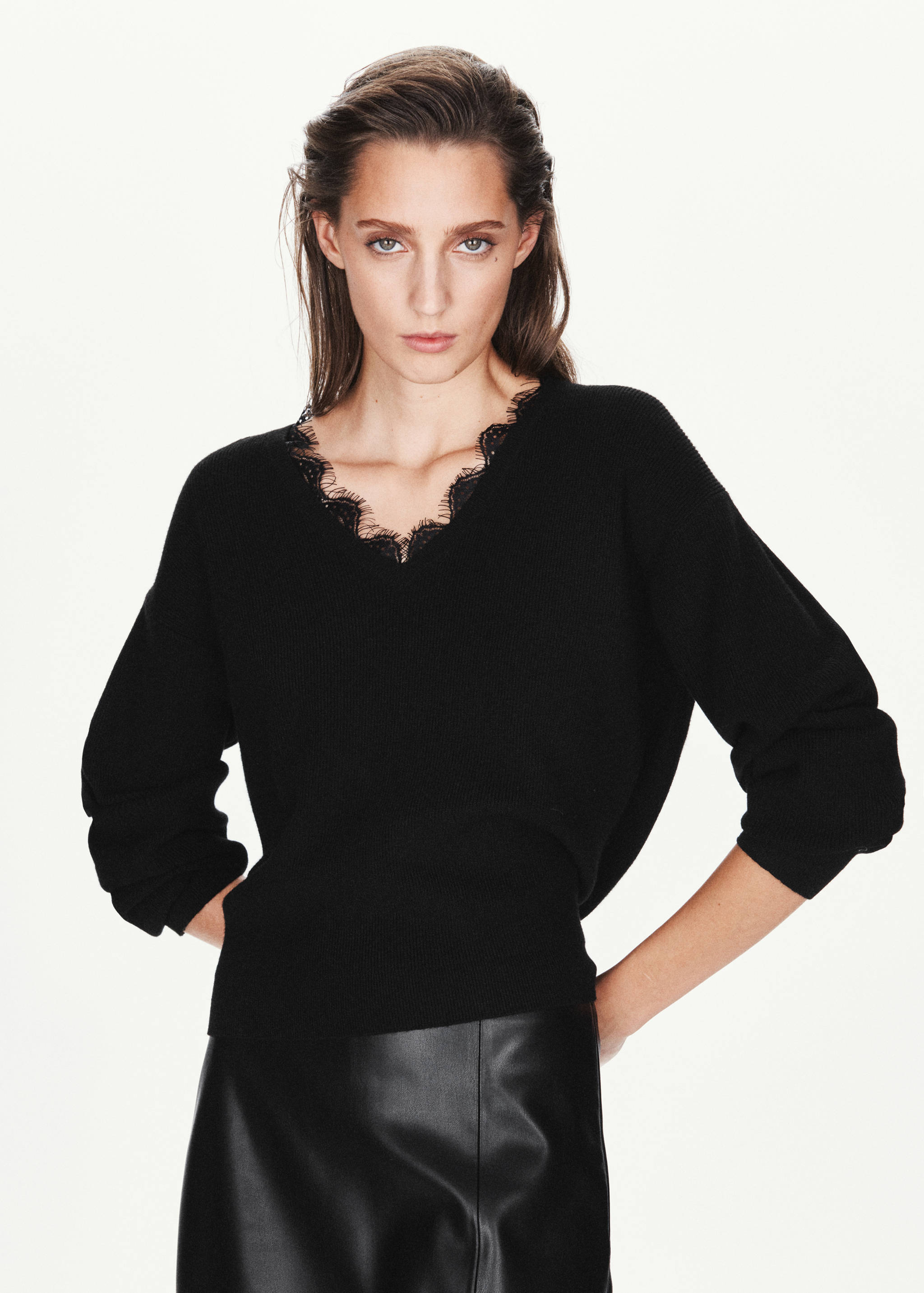 Black knitted jersey with a V-neck and delicate lace trim.