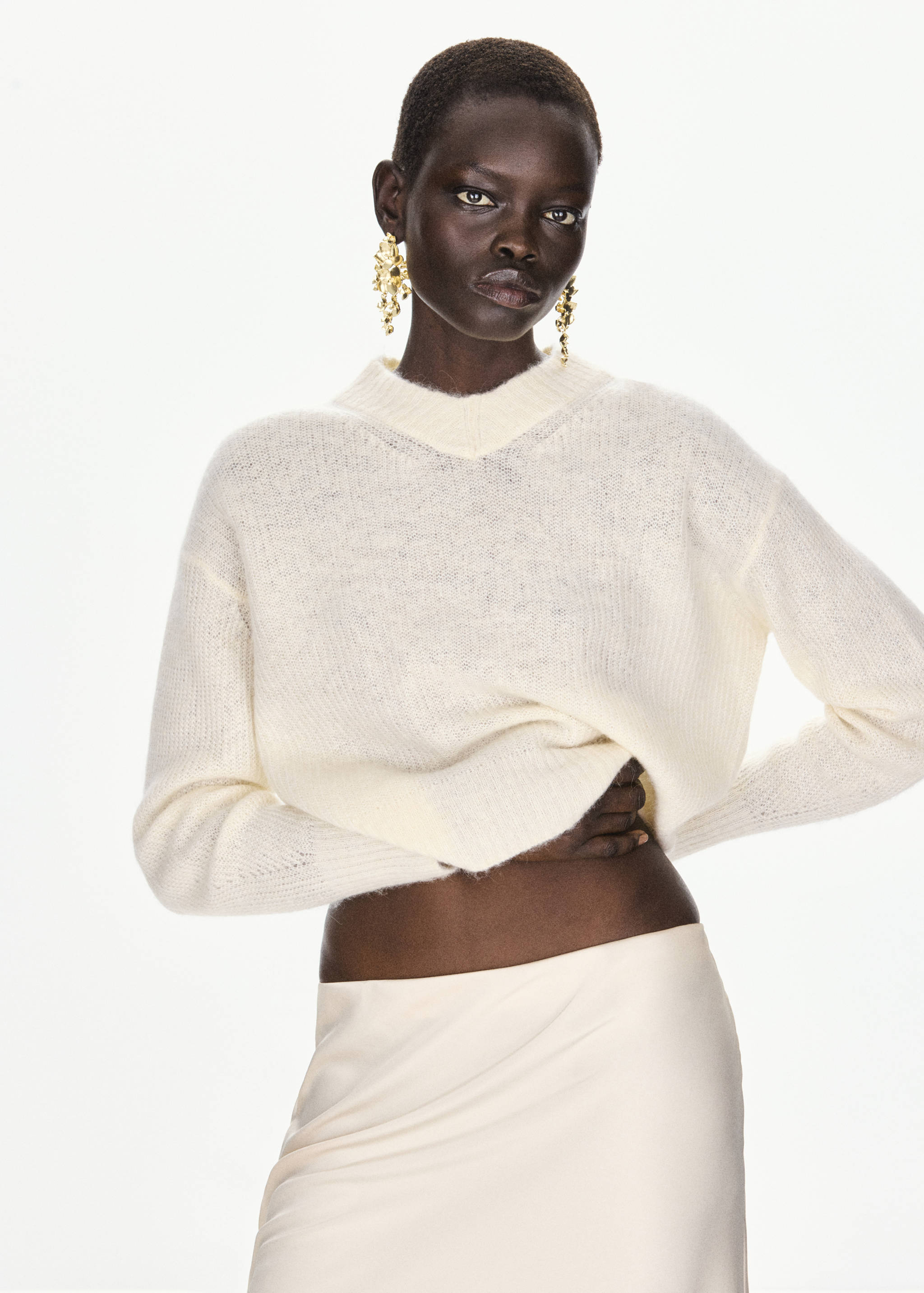 Off-white fuzzy knit jersey with a V-neckline and relaxed fit.
