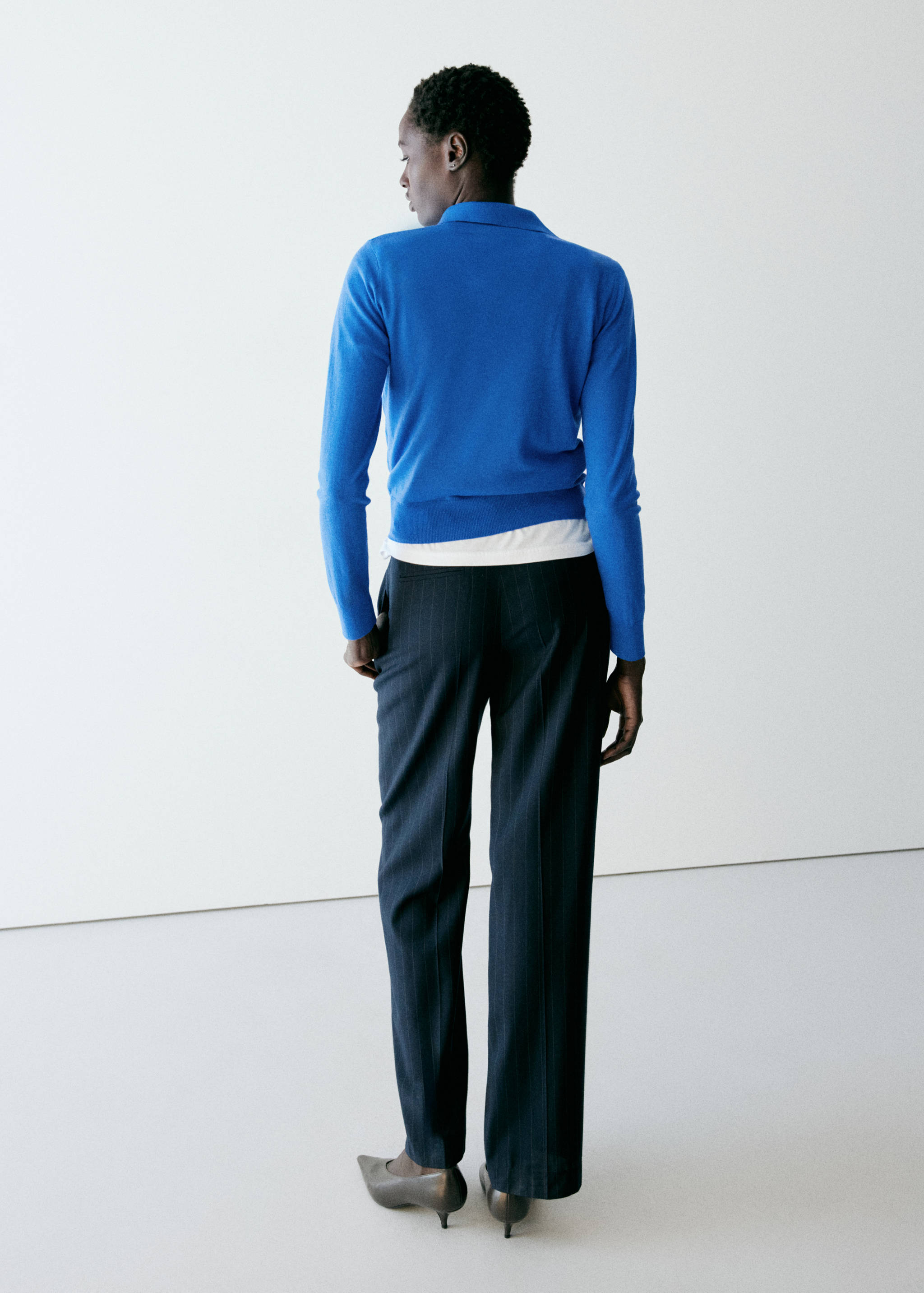 Blue knit jersey with long sleeves and a polo collar, back view