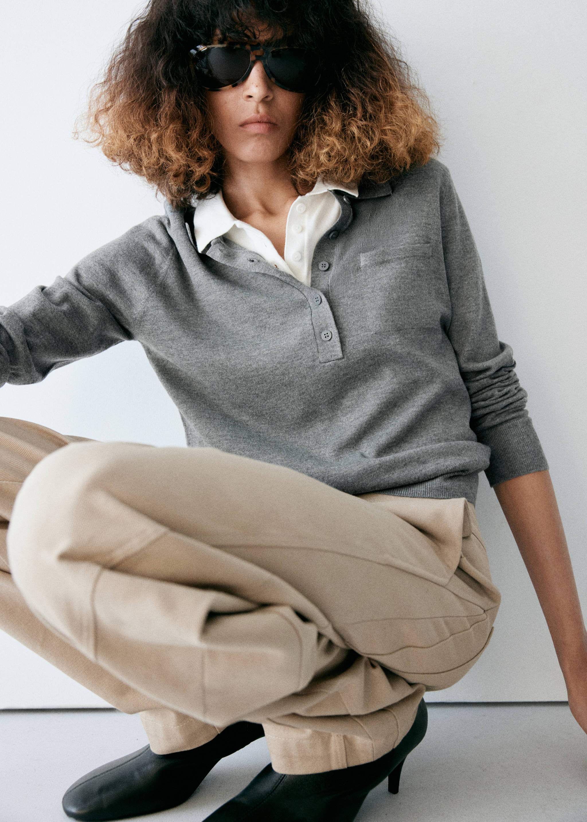 Grey knit polo jersey with a contrasting white collar, button placket, and patch pocket.