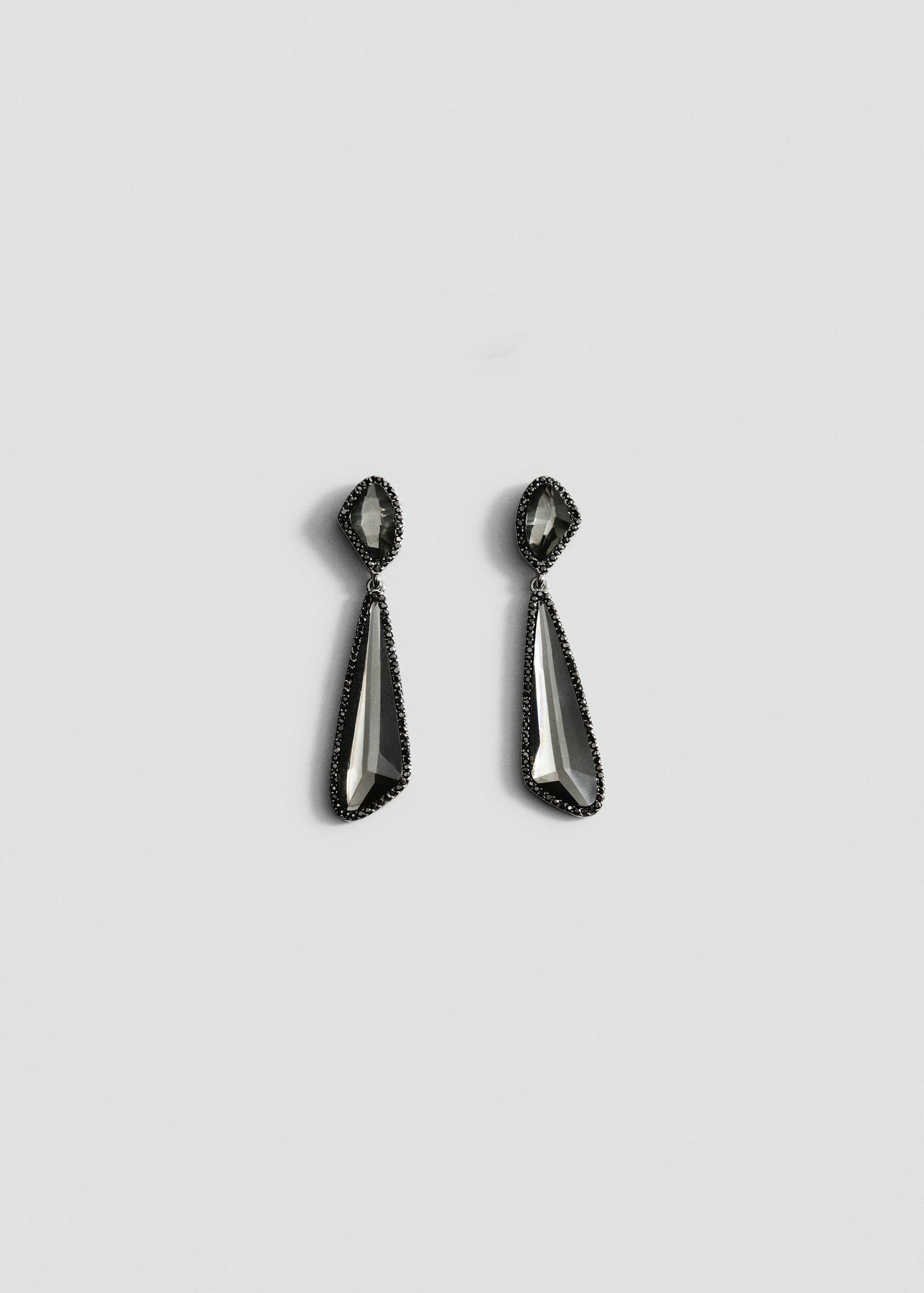 Dark grey crystal drop earrings with asymmetrical faceted stones and pavé edging.