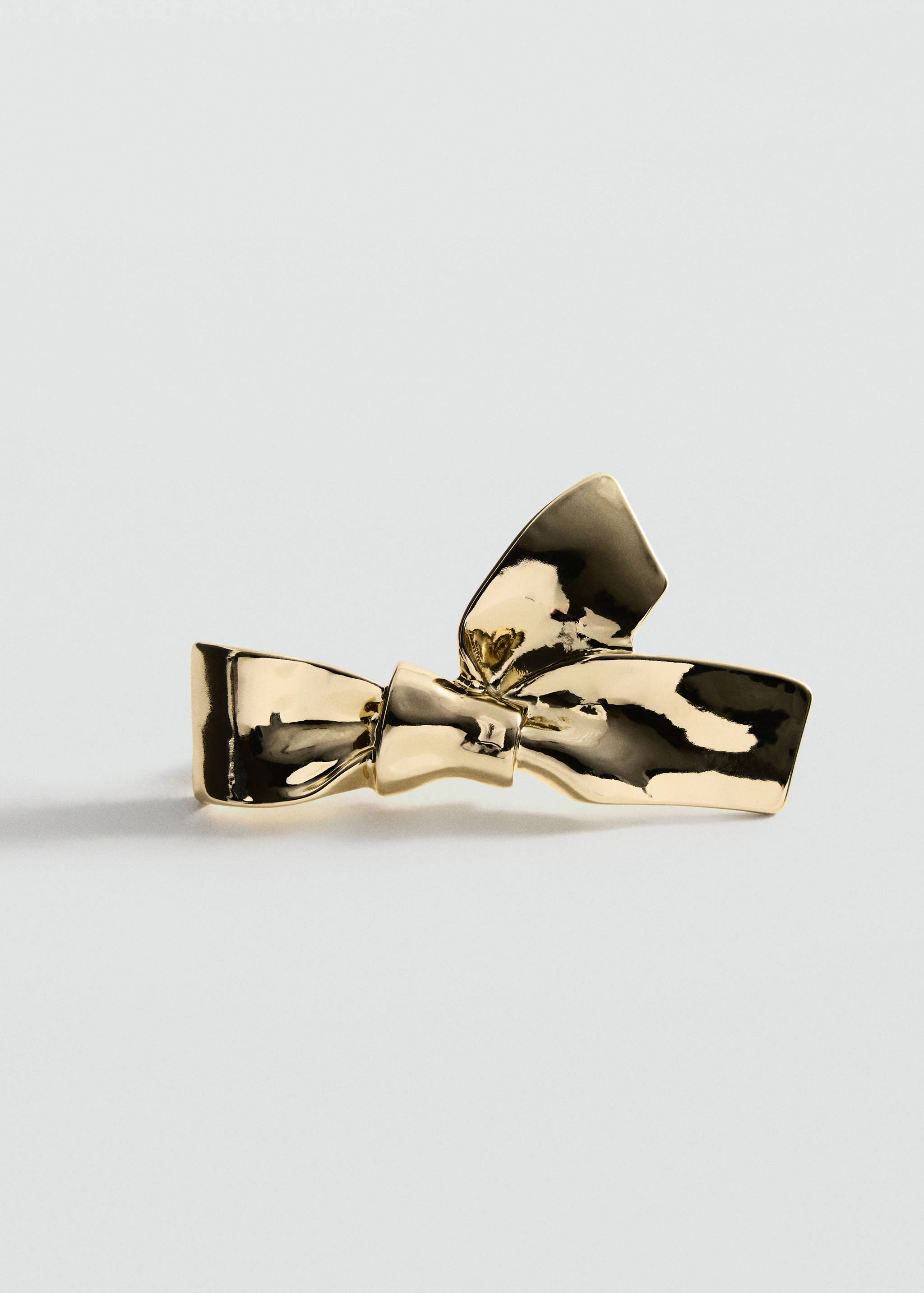 Gold metallic ribbon bow earring with a polished finish.