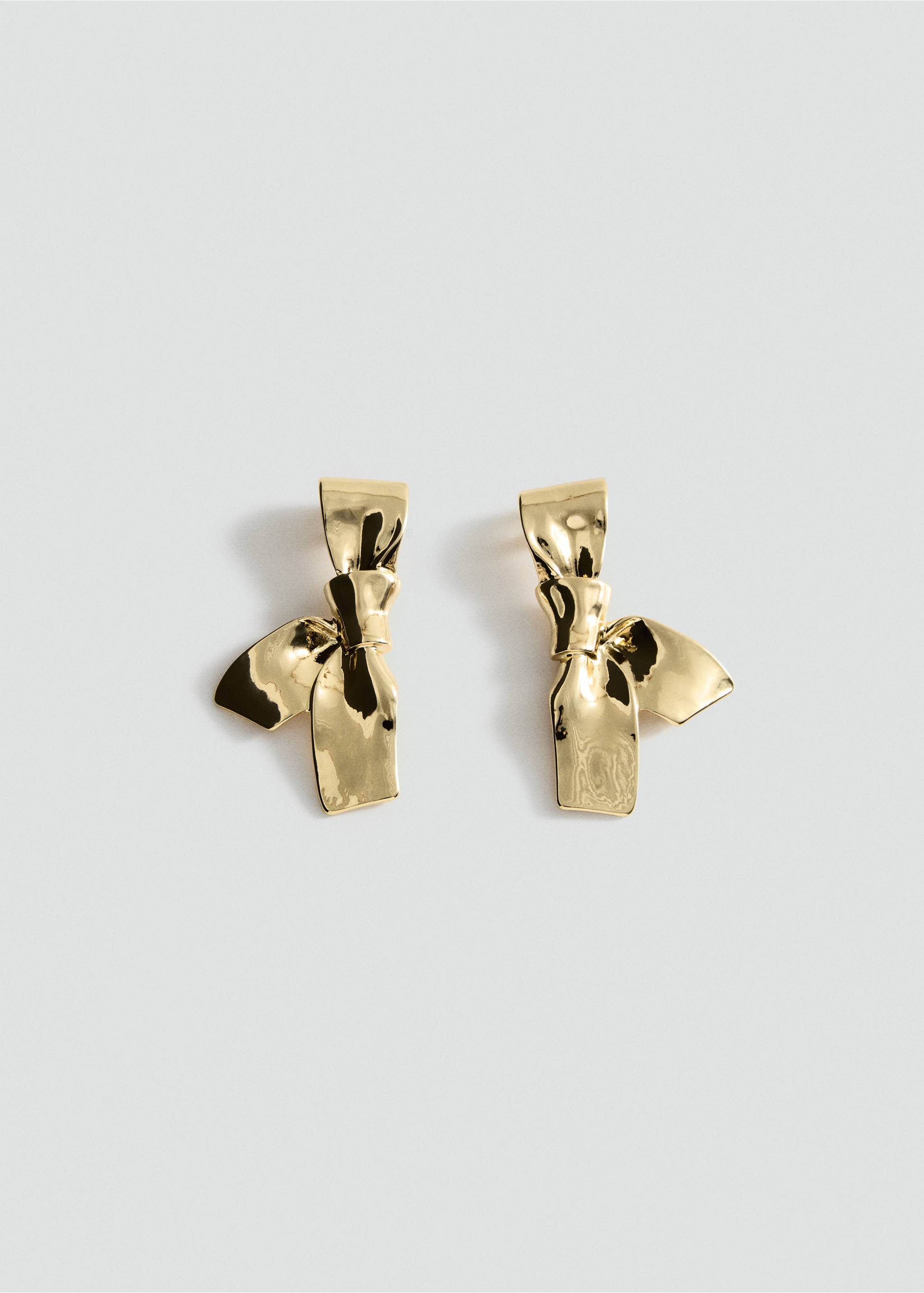 Glossy gold bow earrings in a still life view., Gold. Ref: 37017801-00.