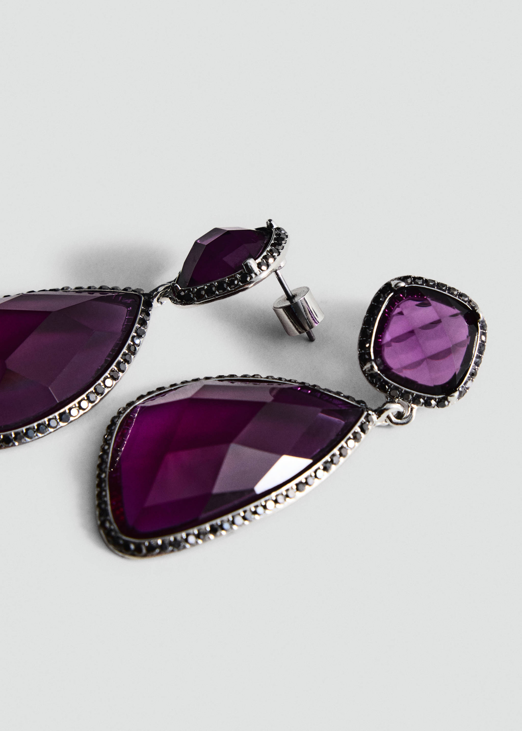 Faceted deep purple drop earrings with sparkling dark metal settings.