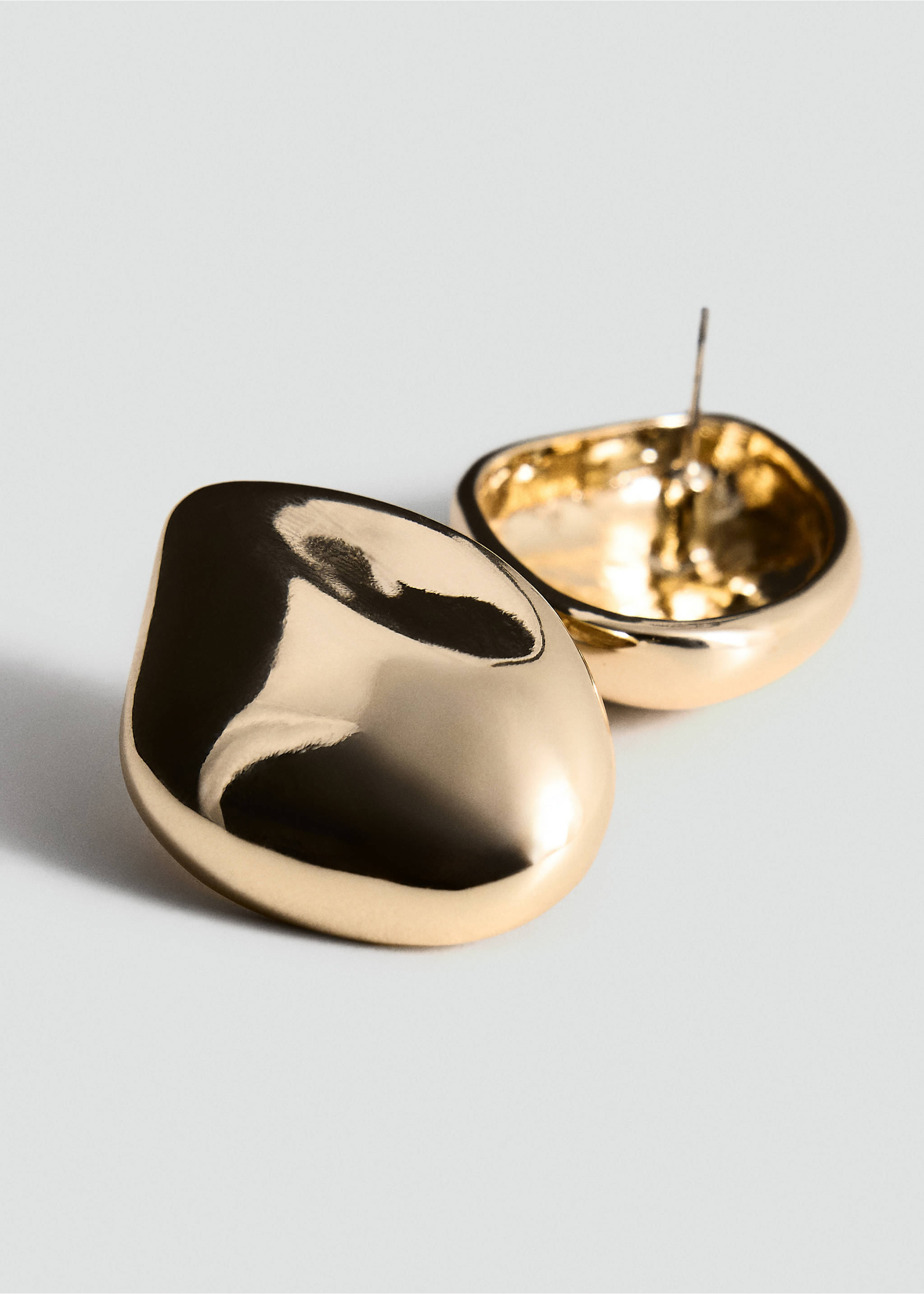 Close-up of shiny gold irregular metallic stud earrings., Gold. Ref: 37017804-00.