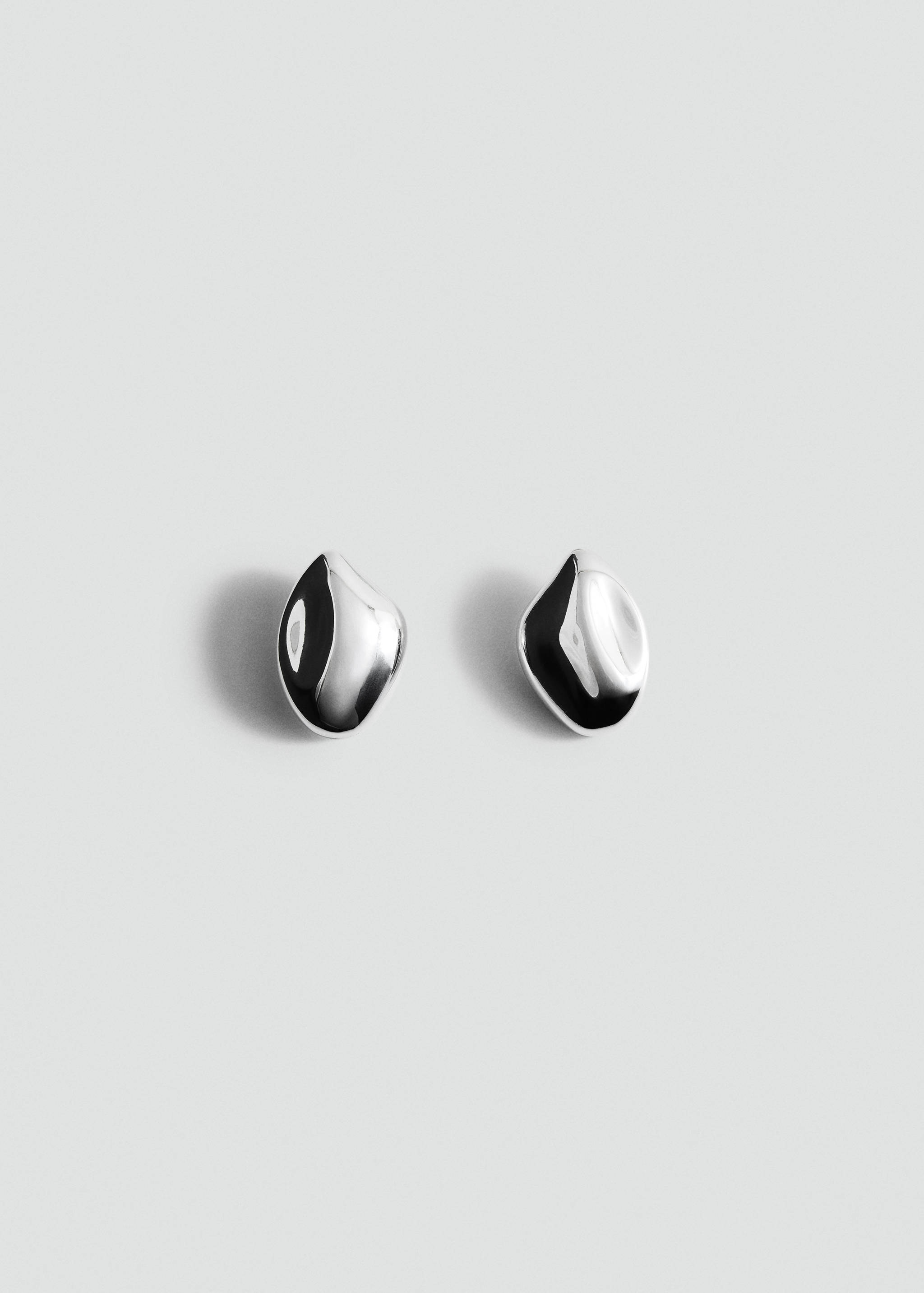 Silver-toned metallic earrings with an asymmetrical, polished droplet shape.