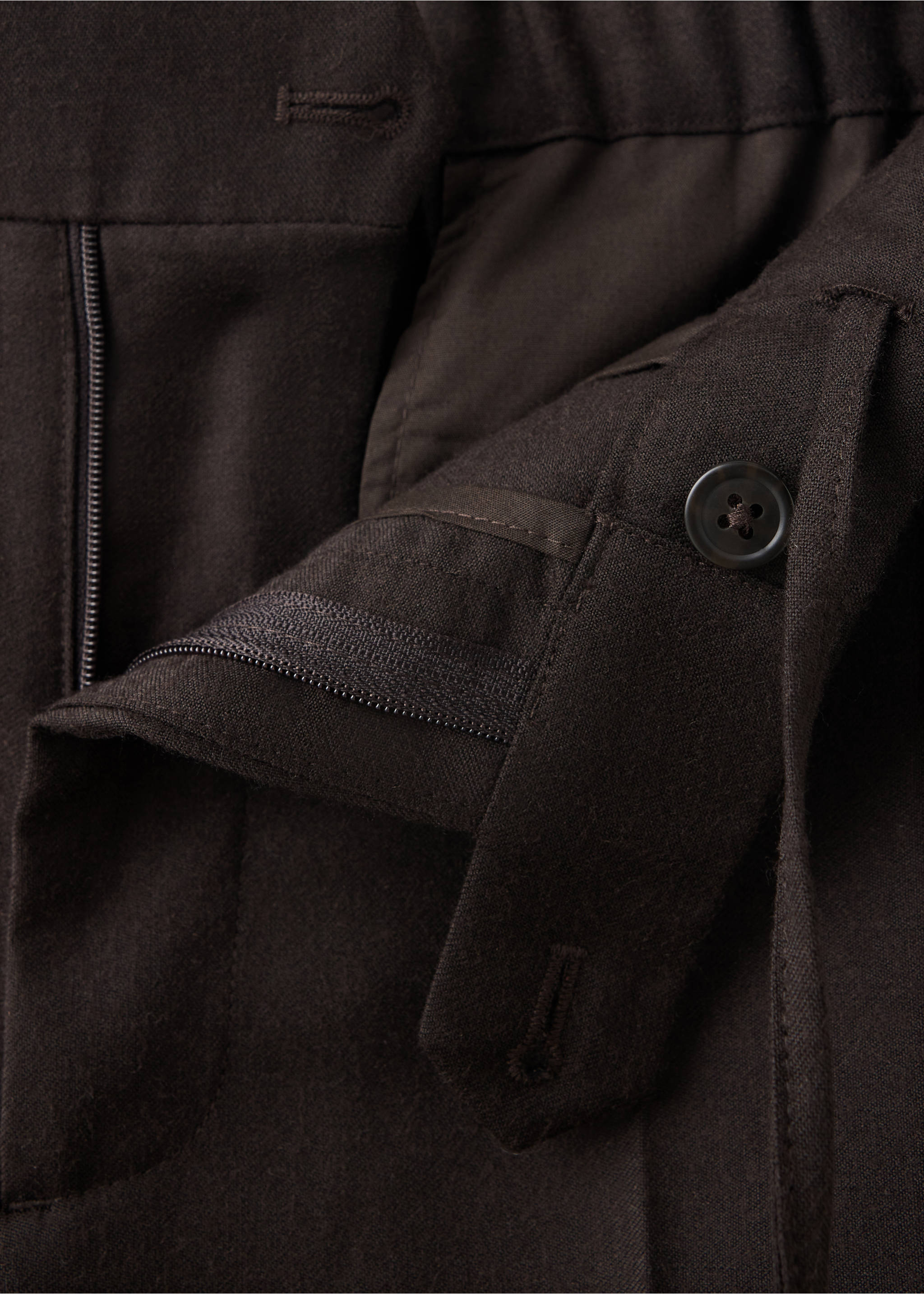 Close-up of the waistband and button fastening detail on dark brown trousers., Brown. Ref: 37017886-00.