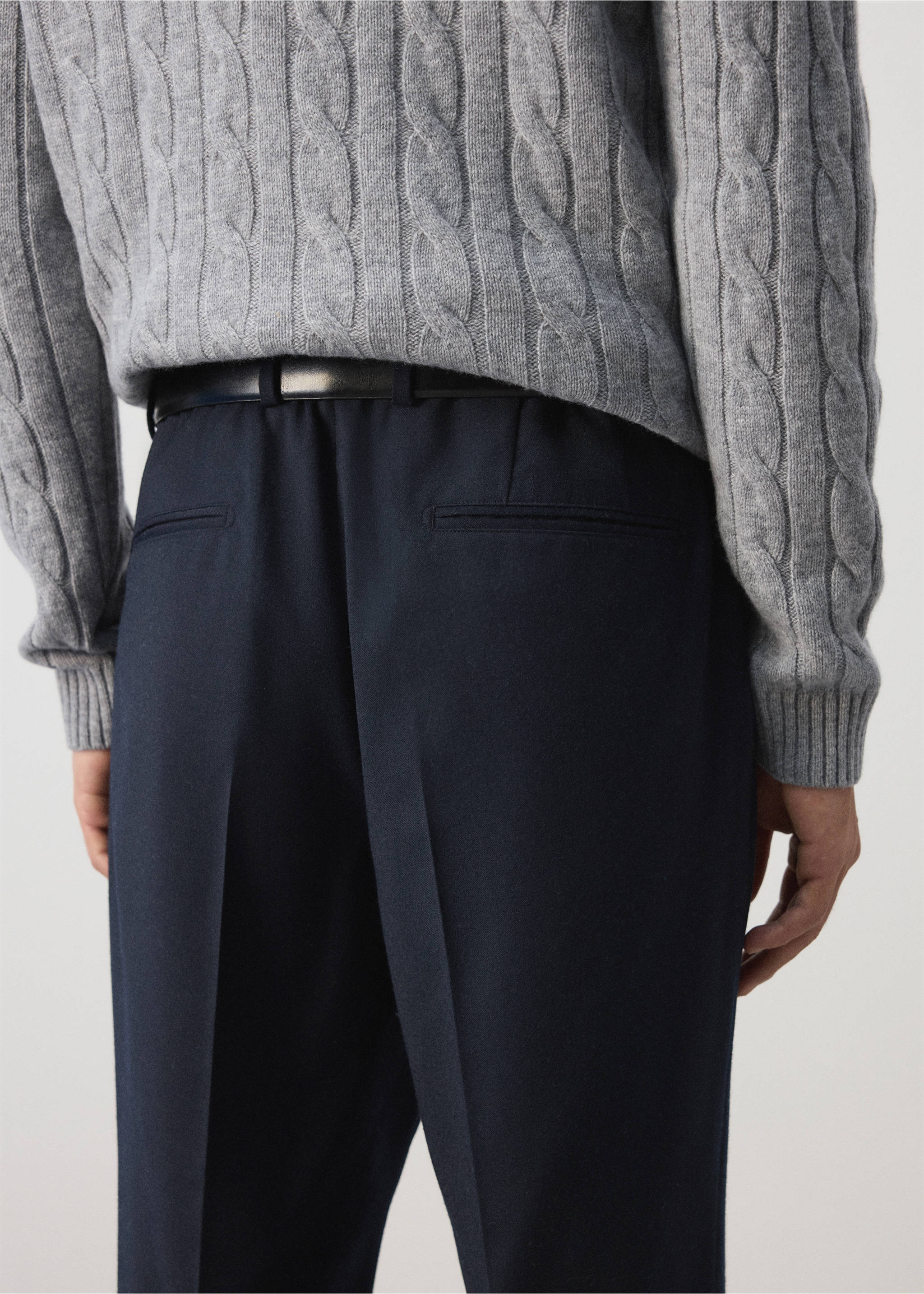 Dark navy blue trousers shown from the back, paired with a black belt and grey cable-knit jumper., Navy. Ref: 37017886-00.