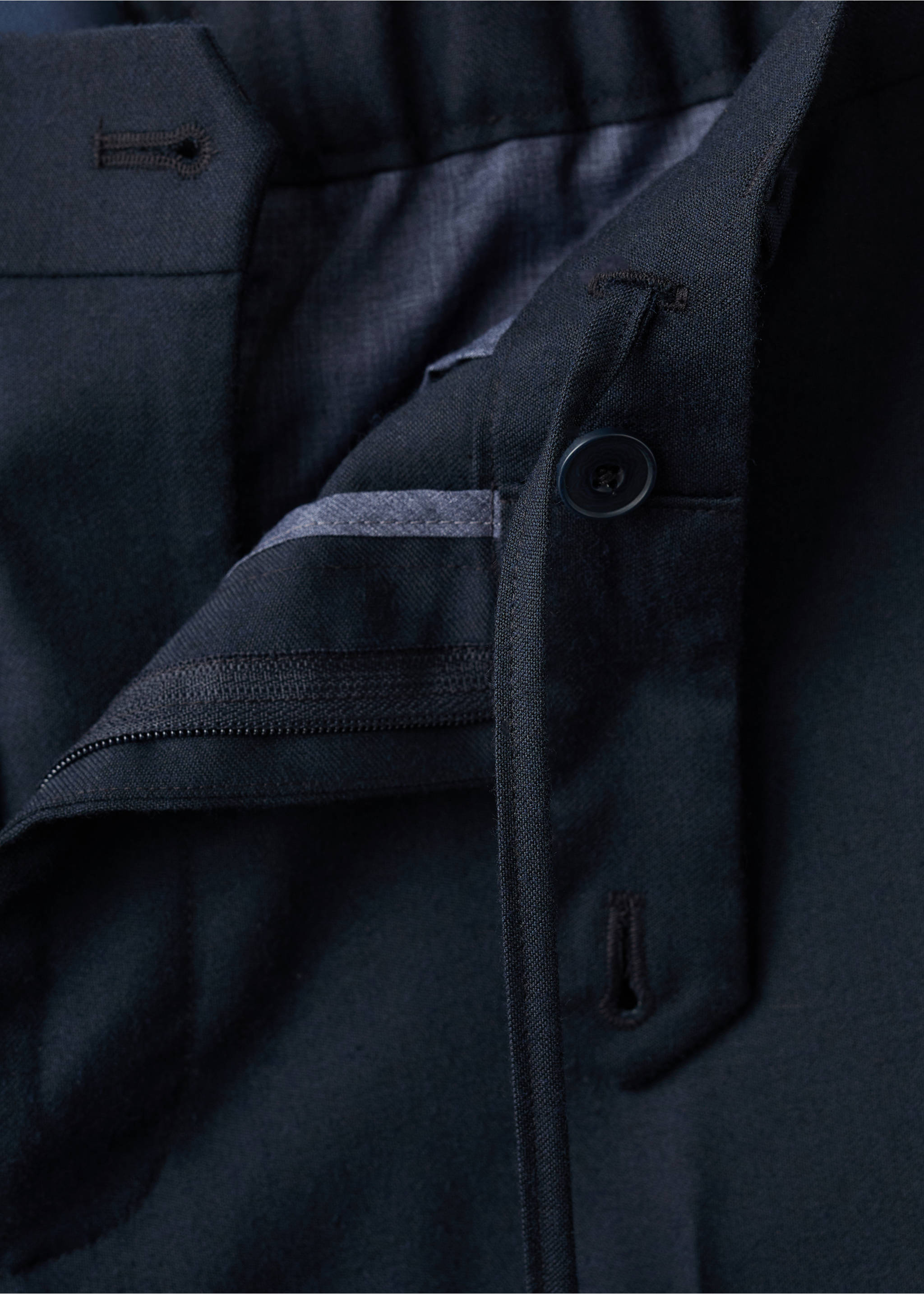 Dark navy trousers fabric detail showing the waistband and button fastening., Navy. Ref: 37017886-00.