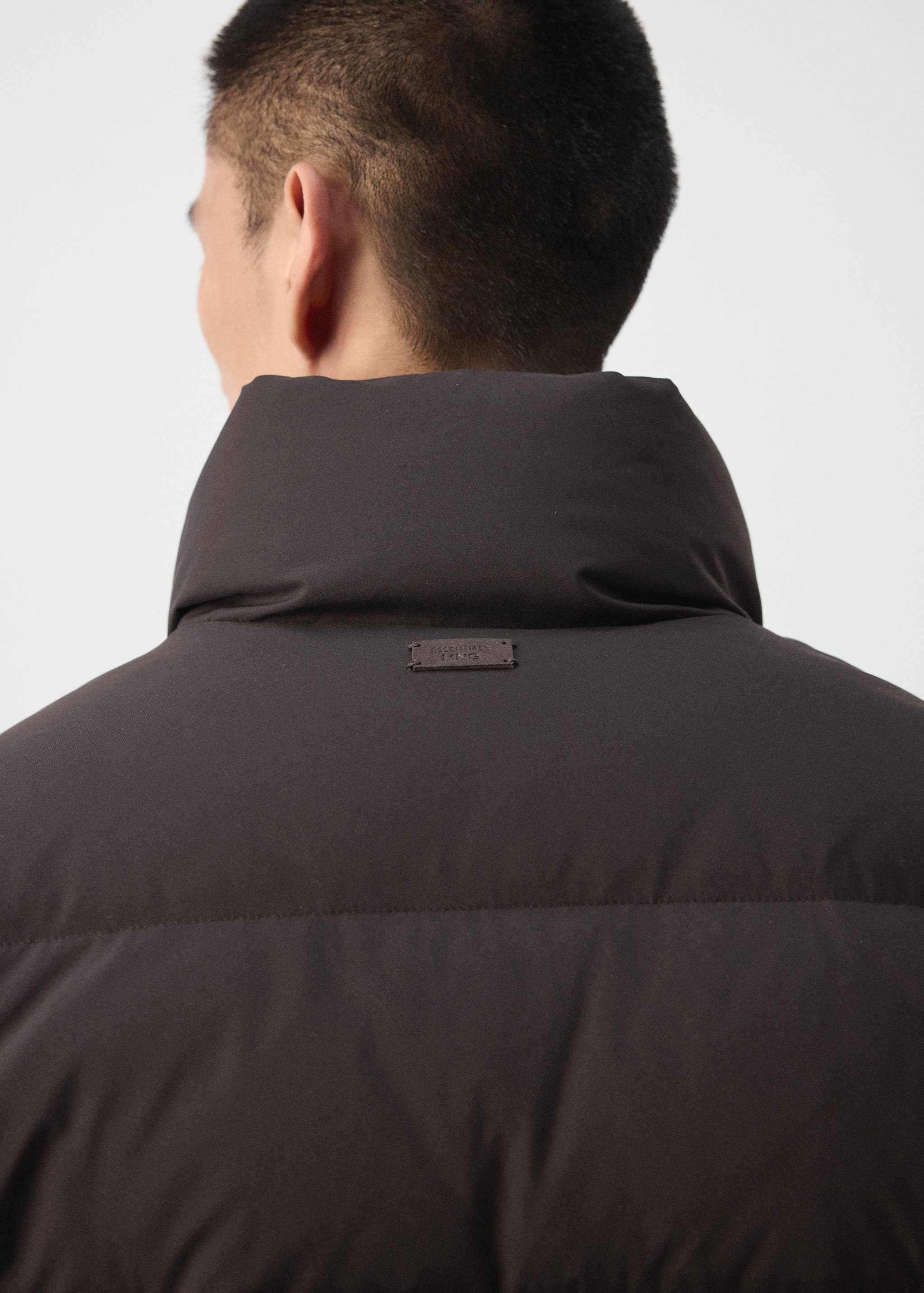 Dark brown anorak detail showing high collar and back label