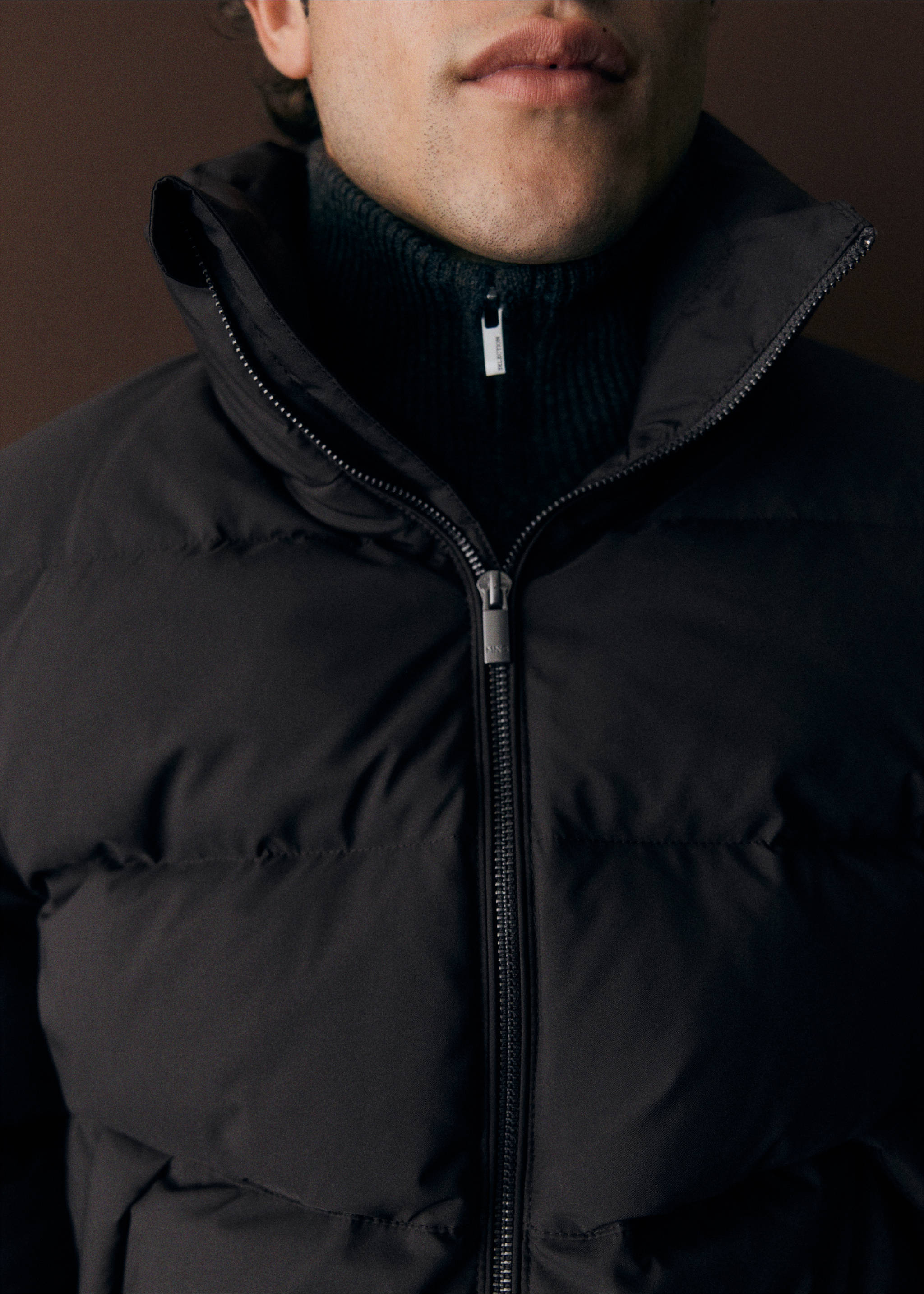 Close-up of a black anorak with a high funnel neck and front zip., Chocolate. Ref: 37017887-00.