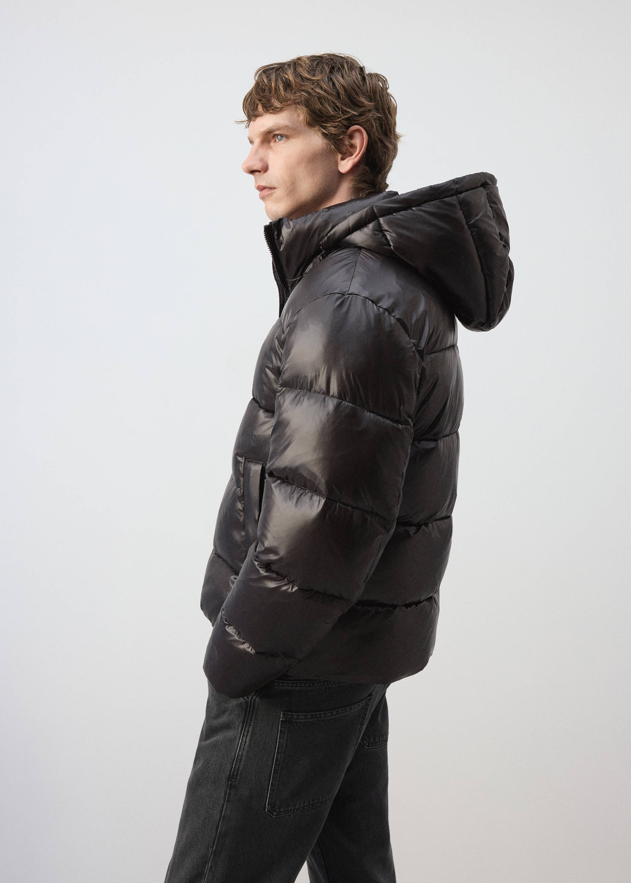 Black hooded puffer anorak with horizontal quilting.