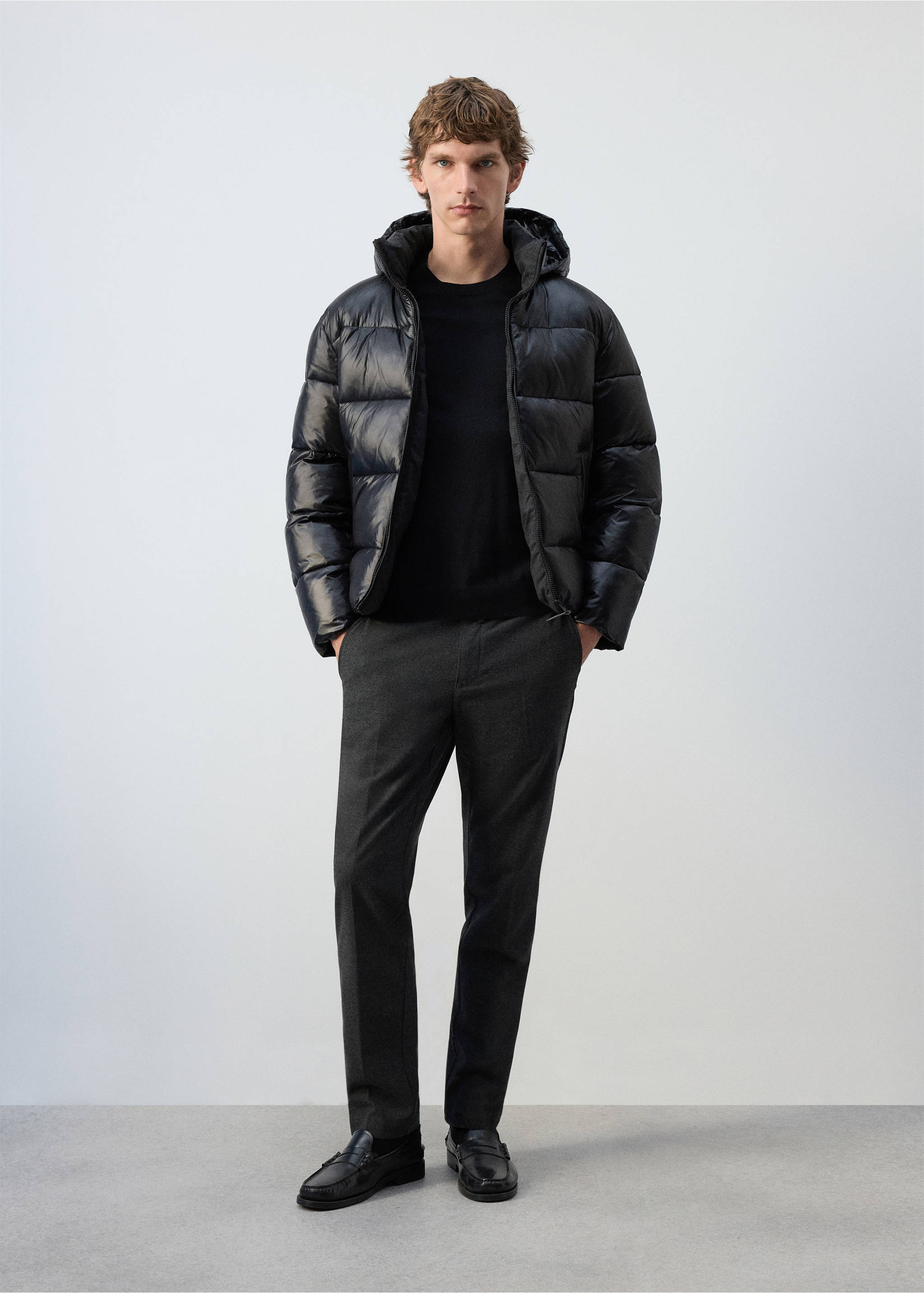 Black quilted anorak with a hood and glossy finish, worn with a jumper and trousers., Black. Ref: 37017892-00.
