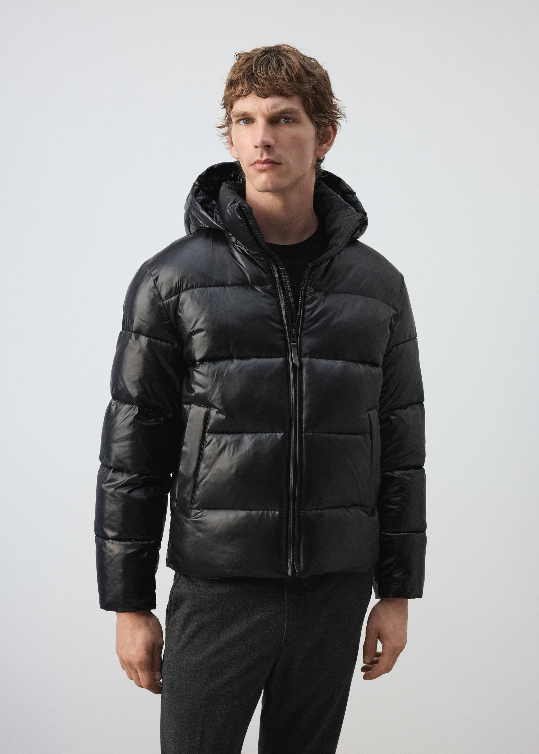 Black shiny quilted anorak with a hood.