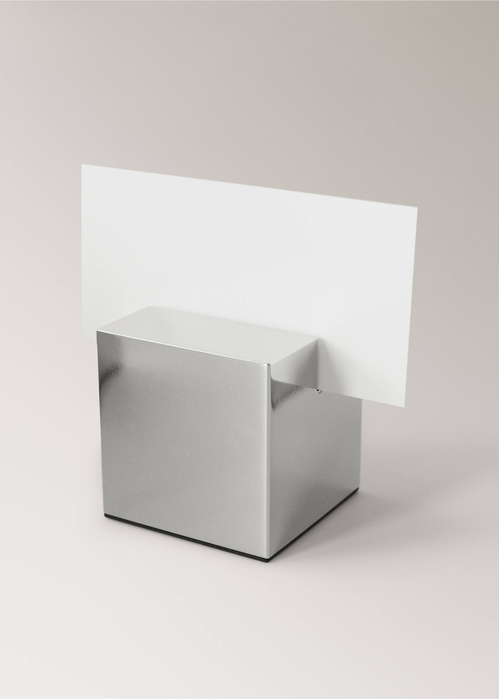 Metallic silver cube gadget with a slotted top holding a card., Silver. Ref: 37017893-00.