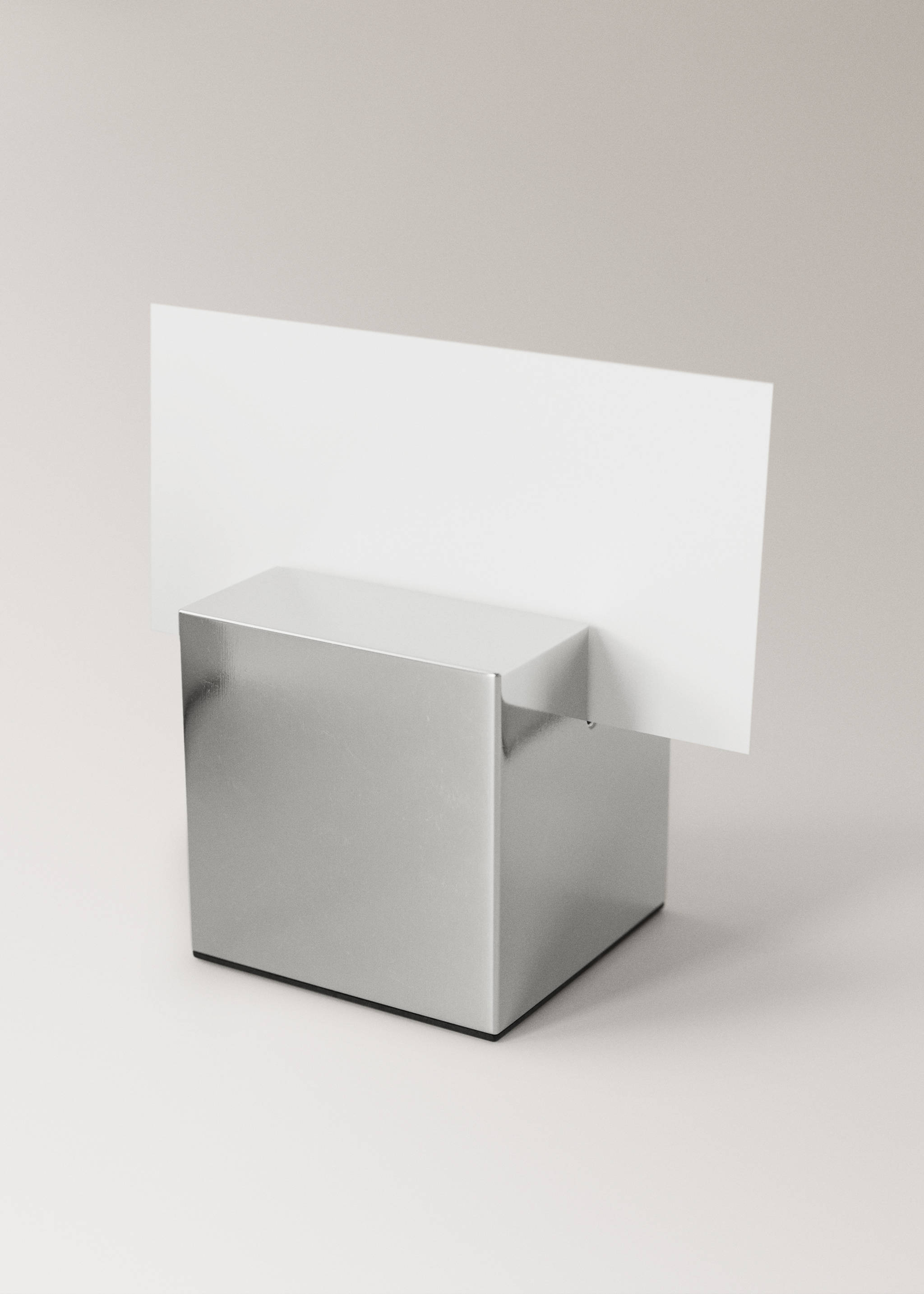 Metallic silver cube gadget with a slotted top holding a card.