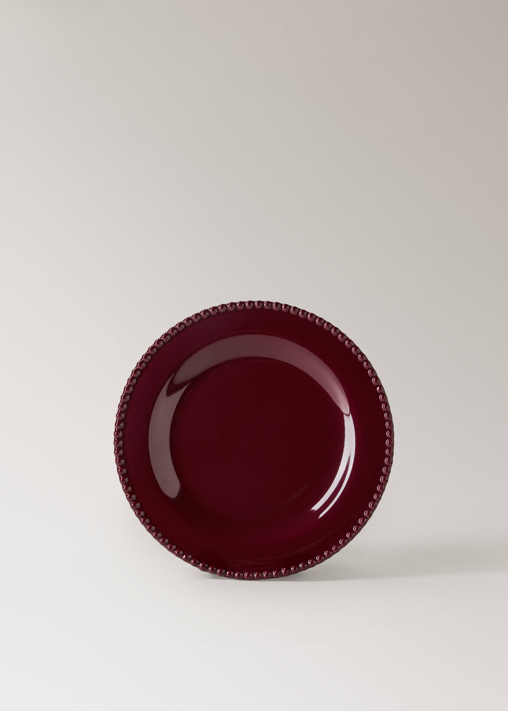 Burgundy plate with a glossy finish and a raised beaded rim.