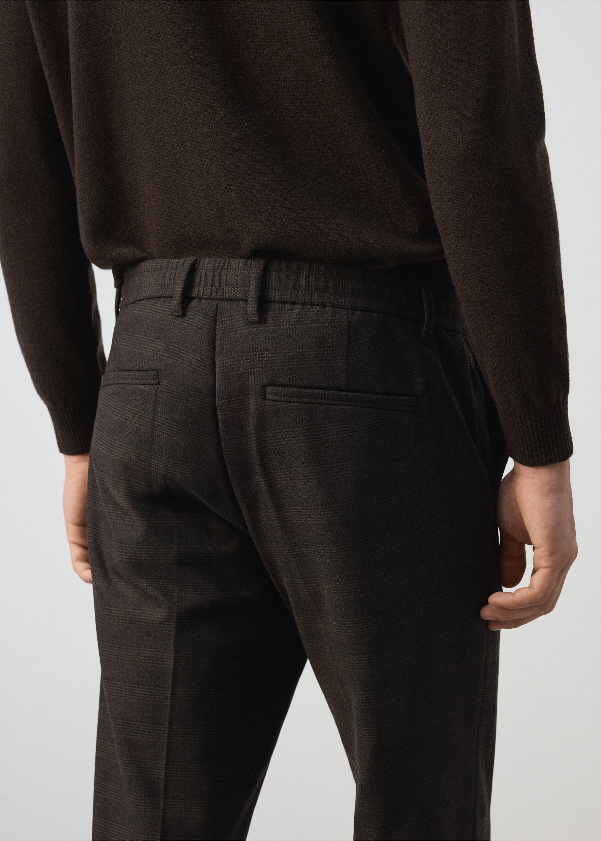 Dark brown checked trousers featuring an elasticated back waistband and welt pockets, rear view., Chocolate. Ref: 37017902-00.