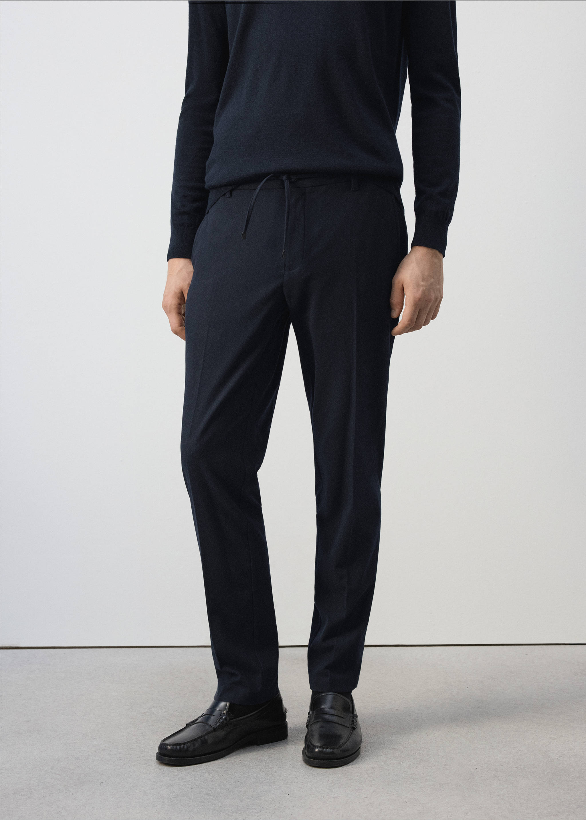 Navy blue trousers with a drawstring waistband worn with a dark sweater., Navy. Ref: 37017903-00.