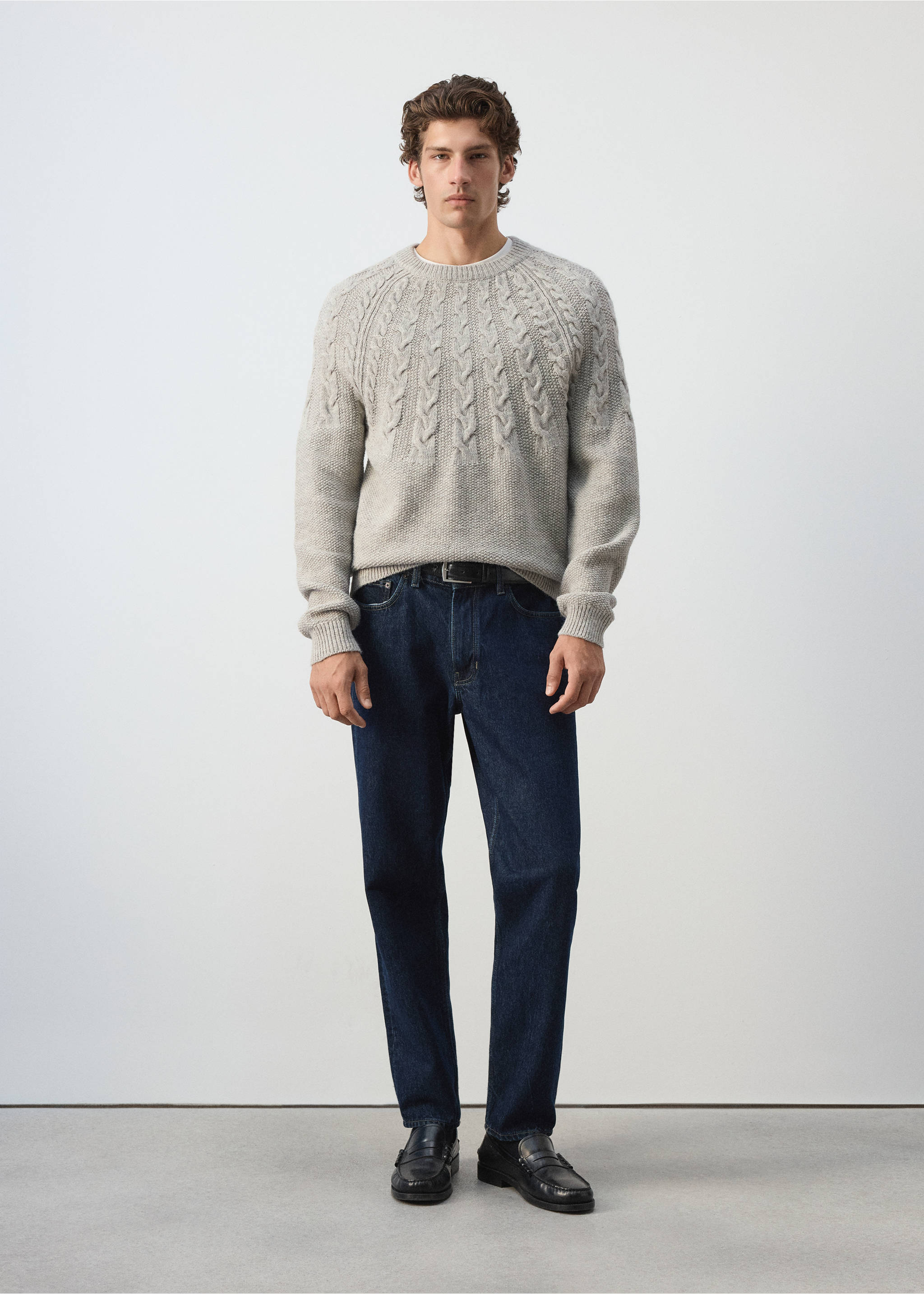 Grey crew-neck knit sweater with a textured cable pattern across the yoke, worn with dark blue trousers., Light/Pastel Grey. Ref: 37017911-00.