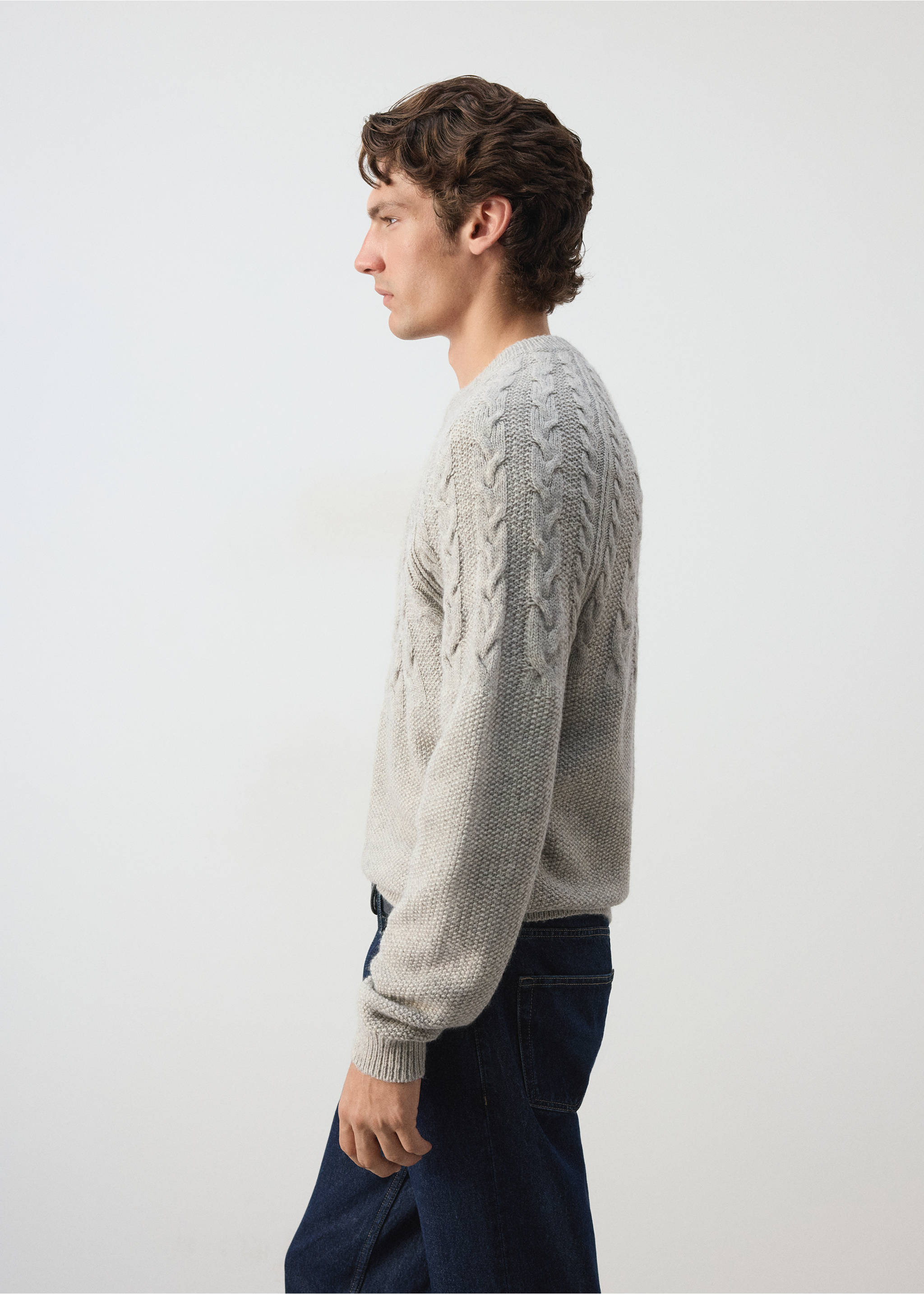 Light grey cable-knit crew-neck jersey worn by a model in profile., Light/Pastel Grey. Ref: 37017911-00.