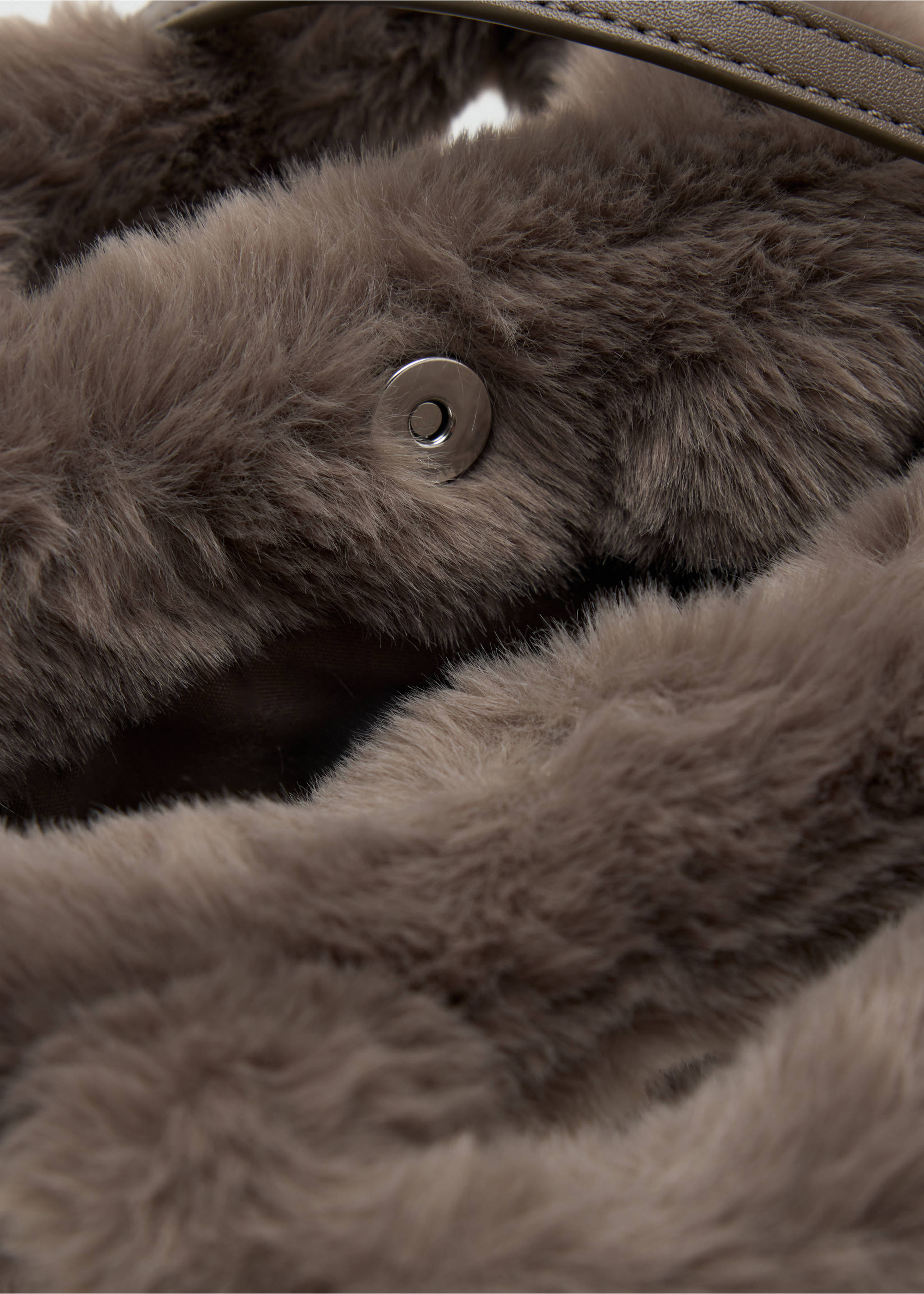 Close-up of a taupe faux-fur mini bag showing its snap closure detail., Medium Brown. Ref: 37017913-00.