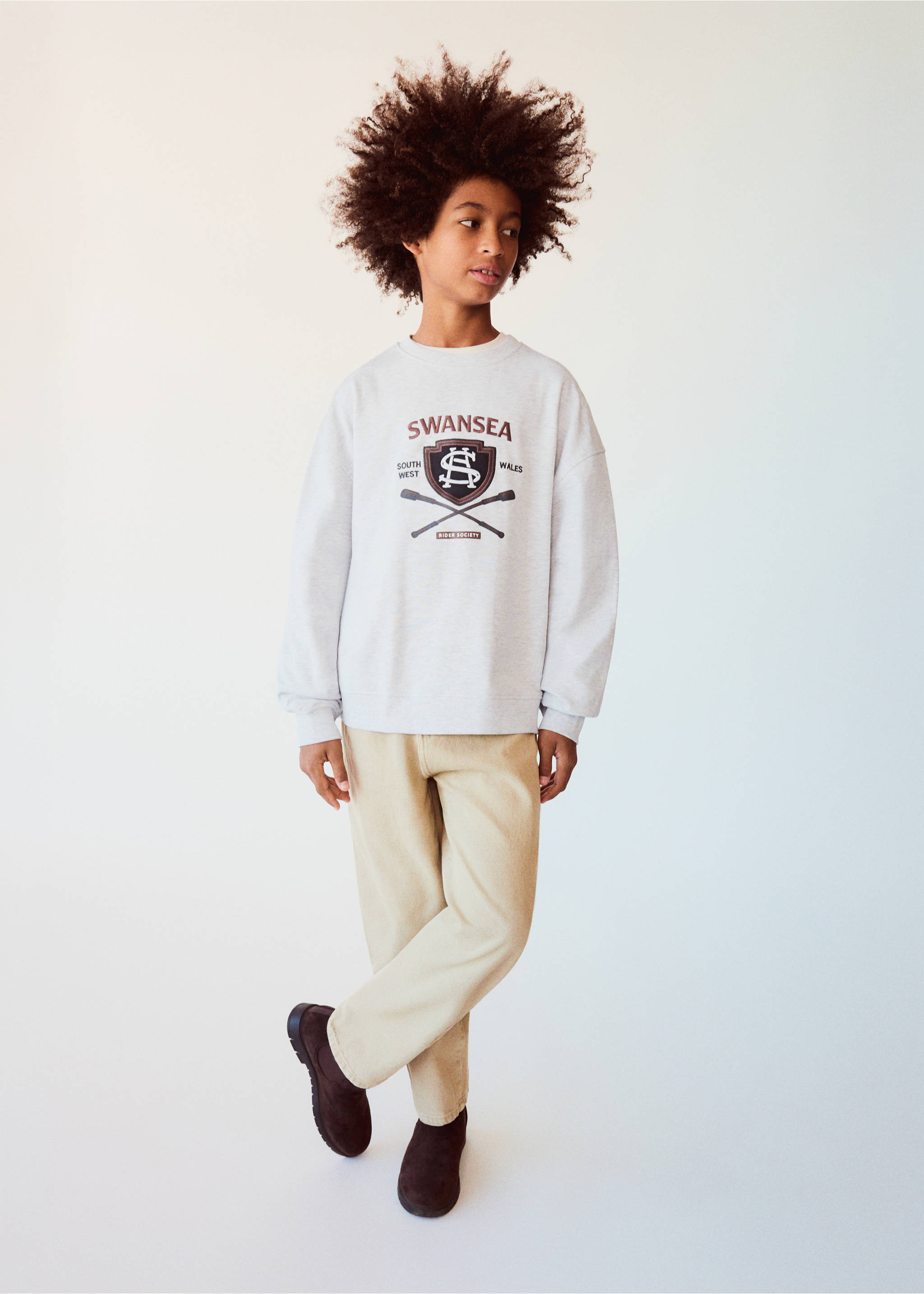 Grey marl sweatshirt with a collegiate chest graphic, worn with beige trousers., Light Heather Grey. Ref: 37017915-00.