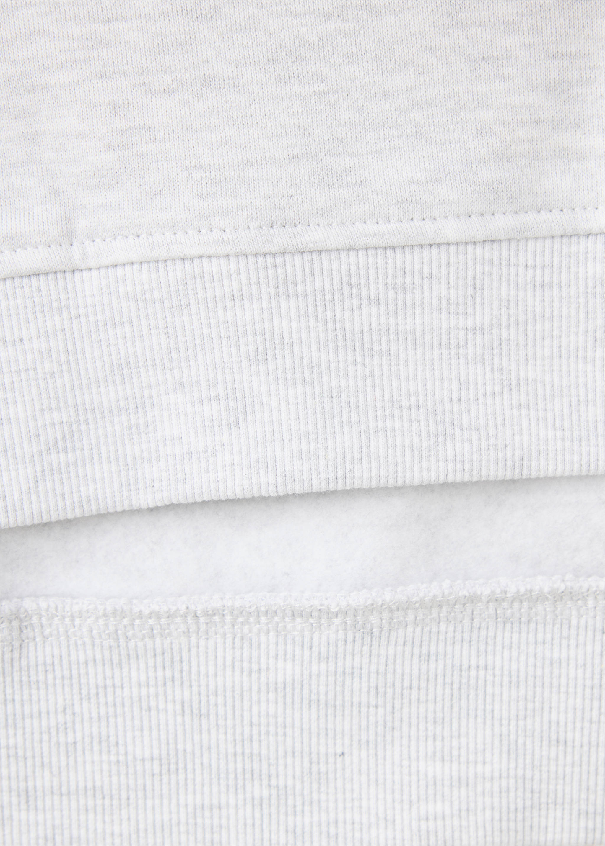Close-up of the grey sweatshirt's fabric texture and ribbed hem., Light Heather Grey. Ref: 37017915-00.