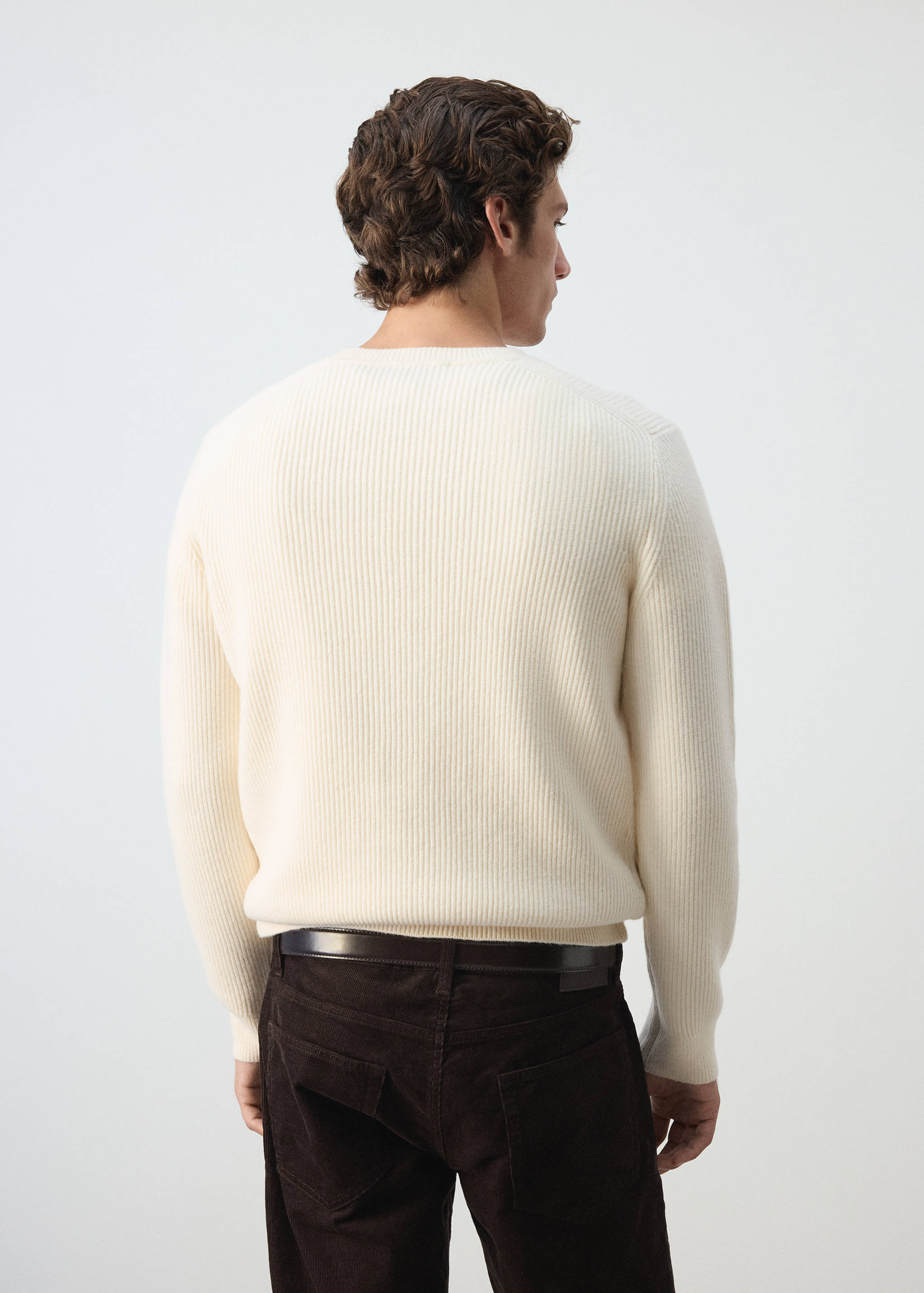 Back view of a cream ribbed knit jumper.