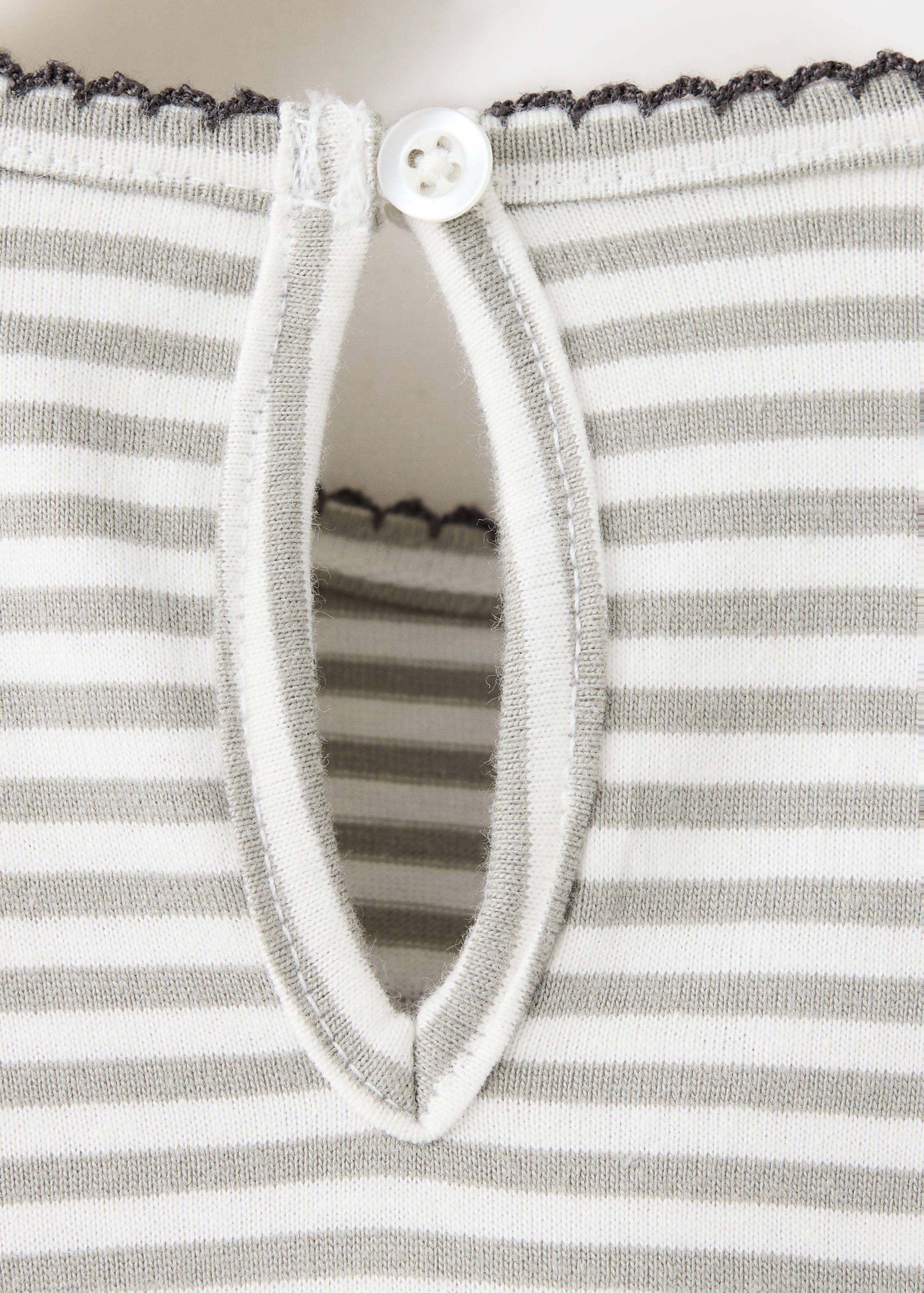 Close-up of a striped kids' t-shirt with a back keyhole button closure.