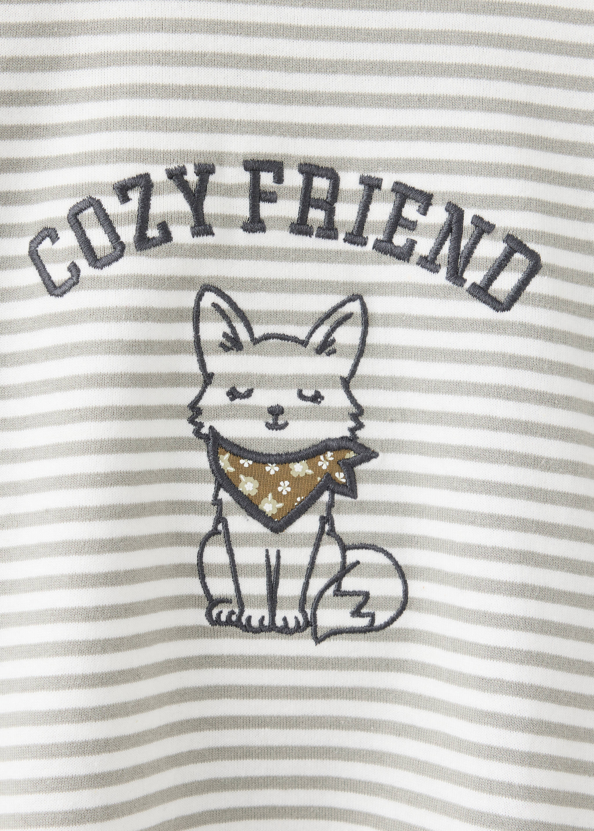 Close-up of a striped children's t-shirt featuring an embroidered fox graphic and COZY FRIEND text.