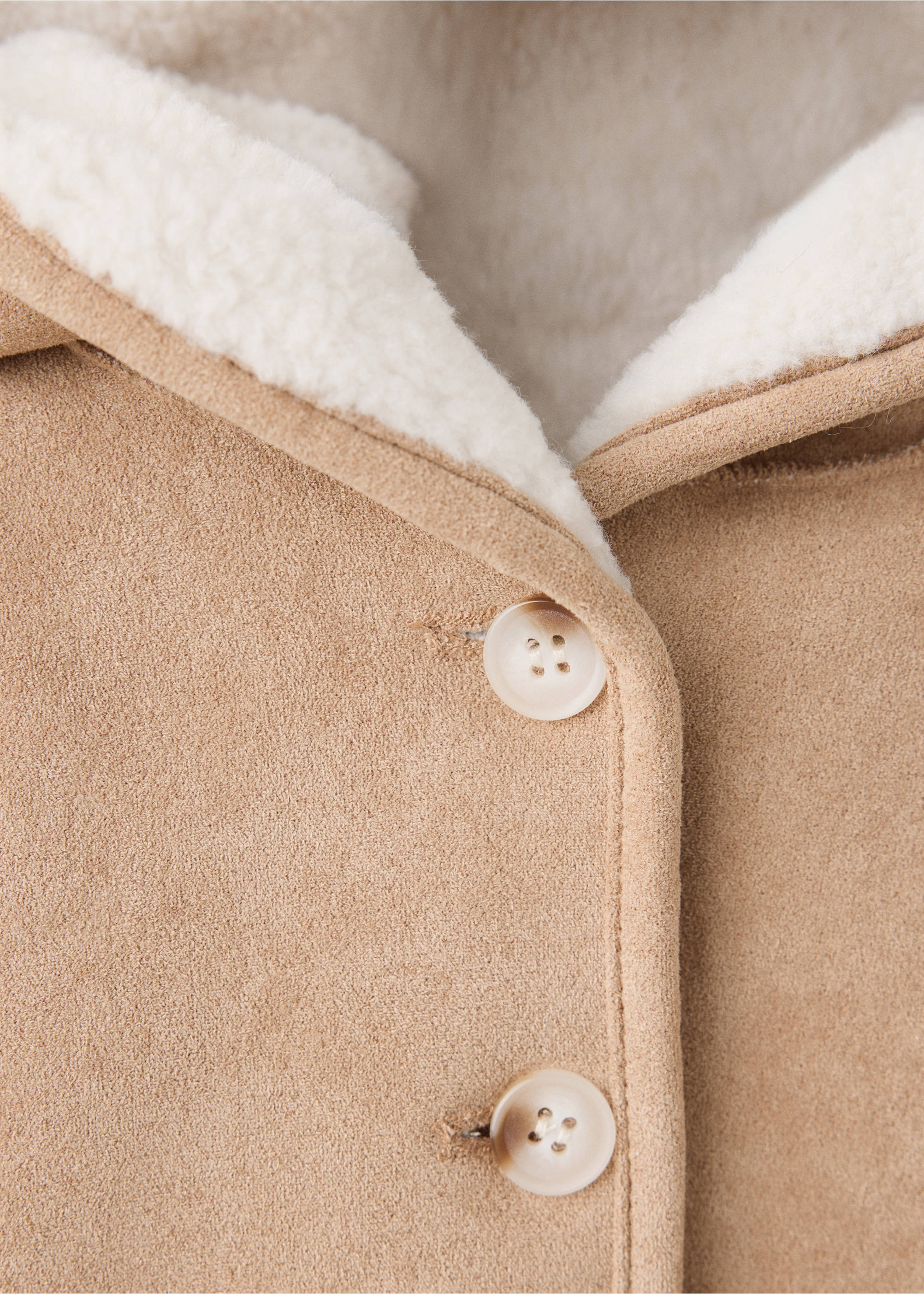 Close-up of a beige children's coat with faux-shearling lining and buttons., Medium Brown. Ref: 37017929-00.