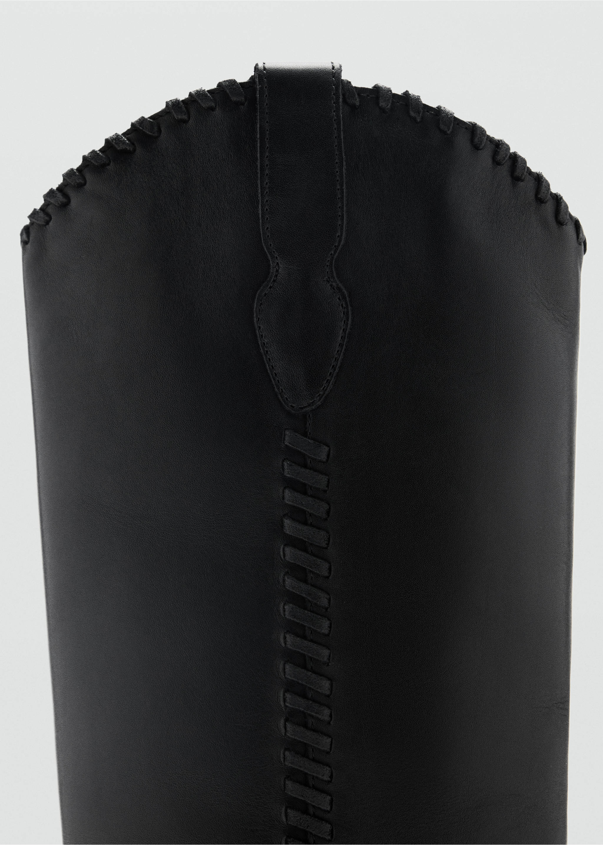 Close-up of black boot shaft with whipstitch detail., Black. Ref: 37017937-00.