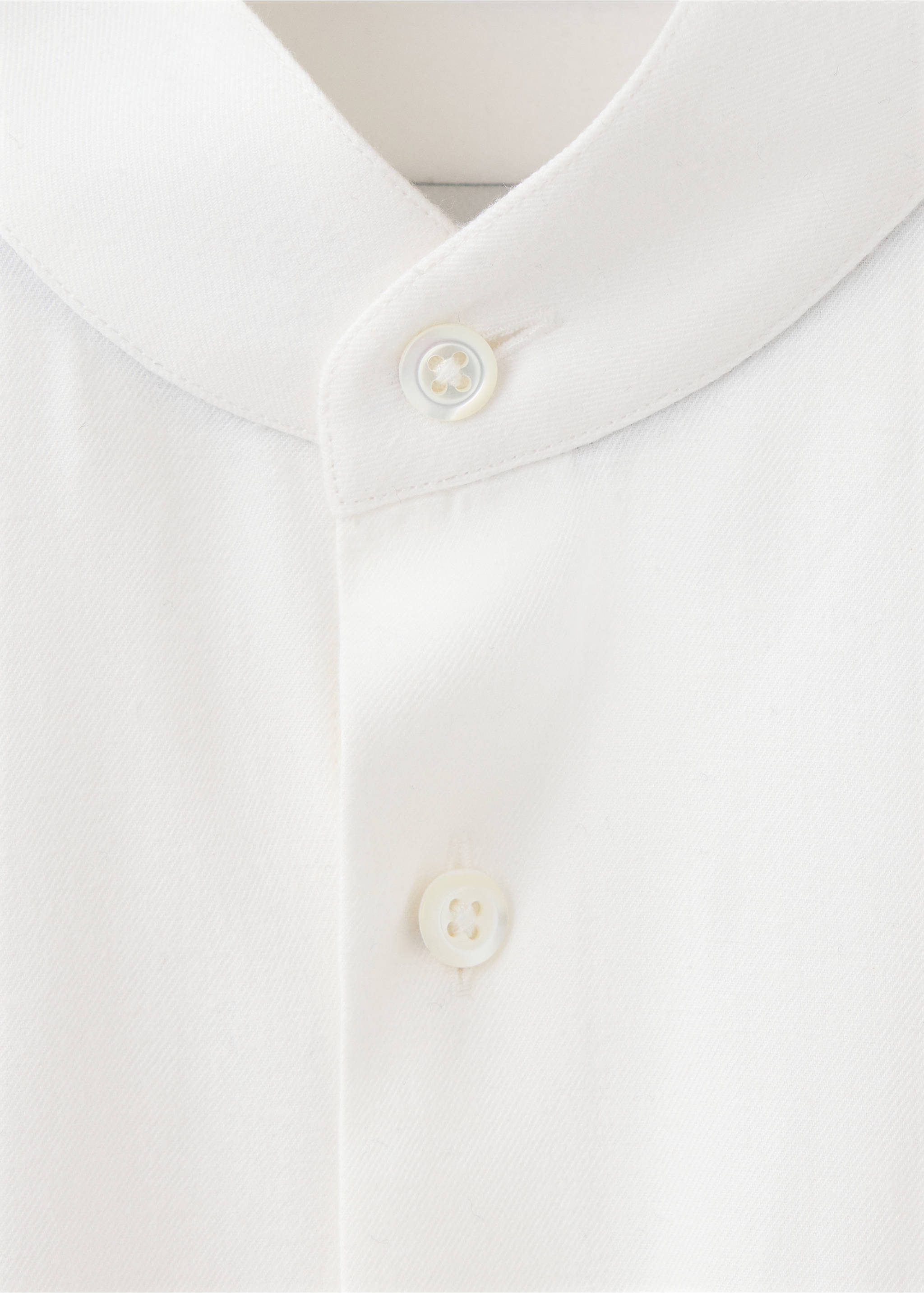 White men's shirt detail showing the mandarin collar and button placket., White. Ref: 37017939-00.