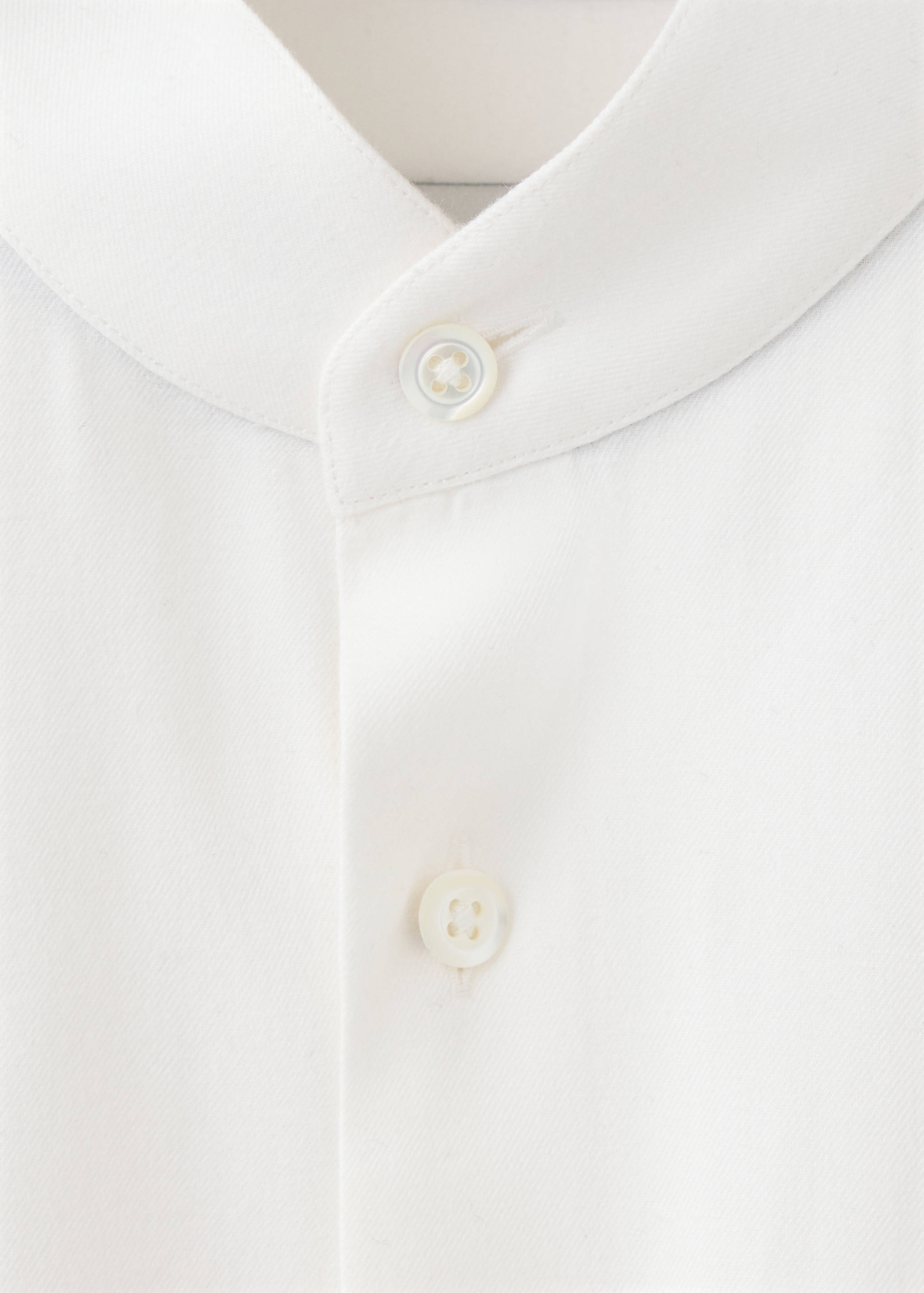 White men's shirt detail showing the mandarin collar and button placket.
